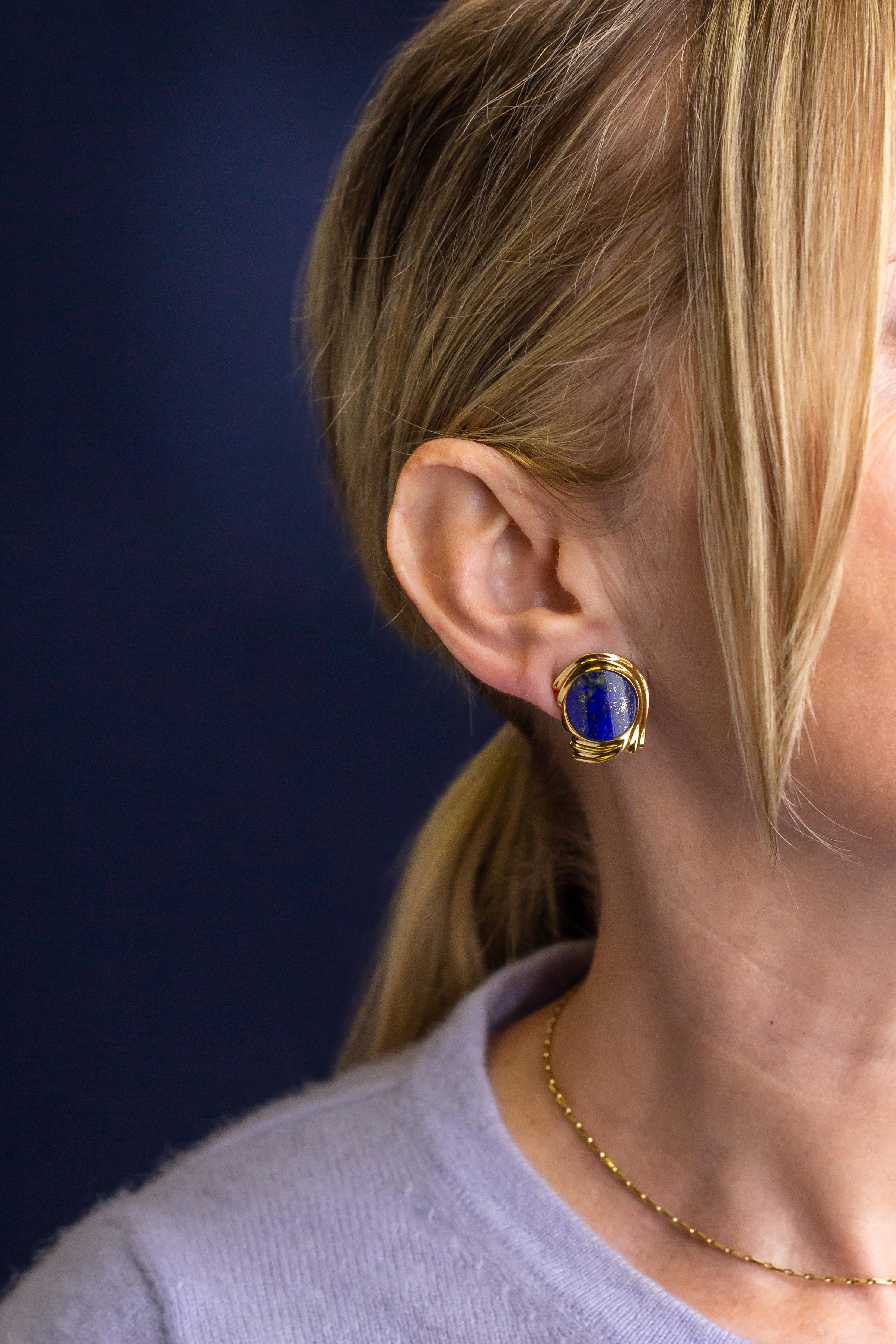 The gold flecks in these lapis and 18 karat yellow gold earrings really make them a standout in our jewel cabinets. Crafted from 18 karat yellow gold the clips each feature a curved circular polished section of lapis lazuli in a vivid blue with