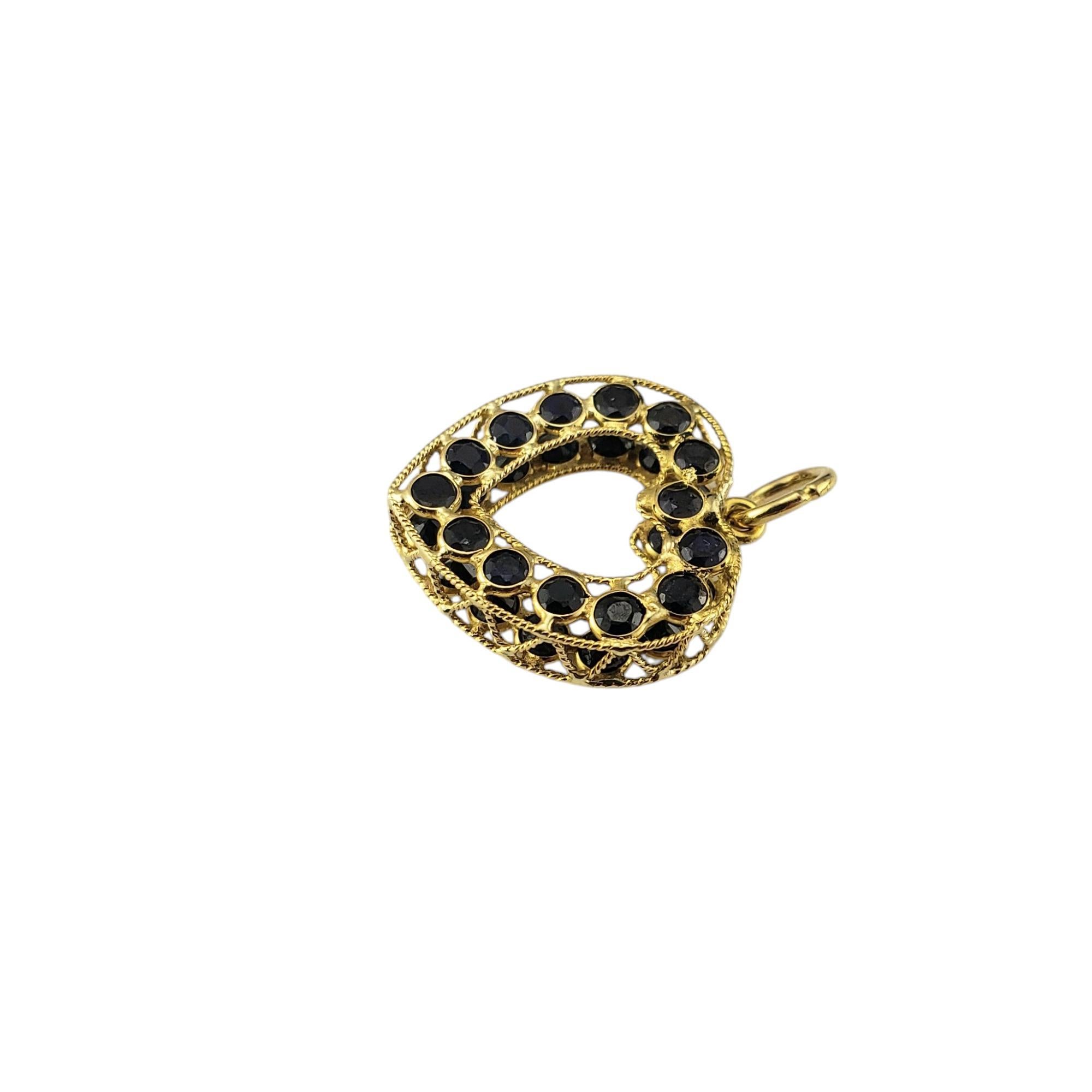 18K Yellow Gold and Natural Blue Sapphire Heart Pendant-

This exquisite pendant features a heart-shaped design crafted in radiant 18K yellow gold. Intricate filigree patterns adorn the surface, showcasing timeless craftsmanship and elegance. Each