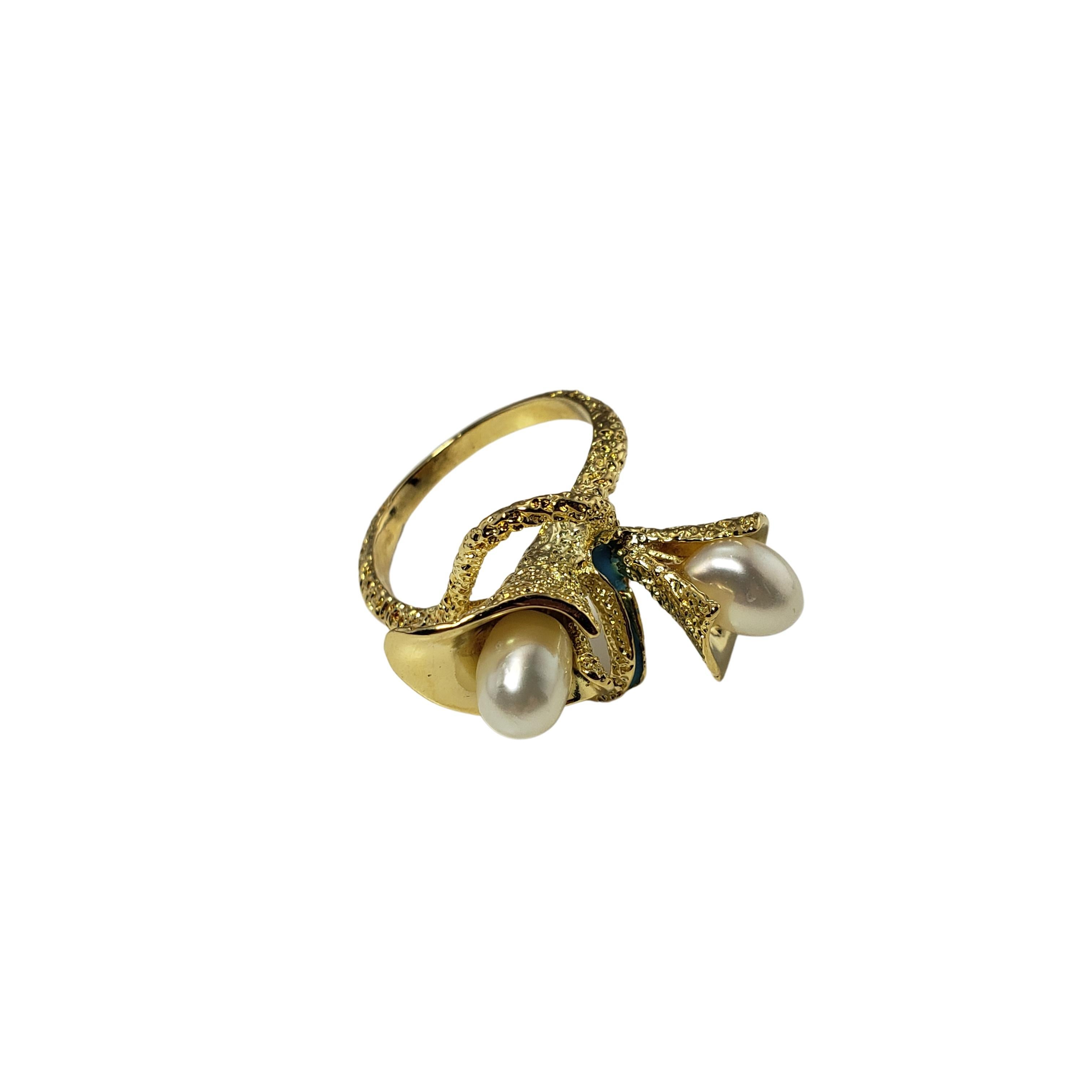 Vintage 18 Karat Yellow Gold and Pearl Calla Lily Ring Size 6.5-

This lovely calla lily ring features two white pearls (7 mm x 6 mm) set in beautifully detailed 18K yellow gold and accented with blue enamel. Shank: 2 mm.

Size: 6.5

Weight: 4.5
