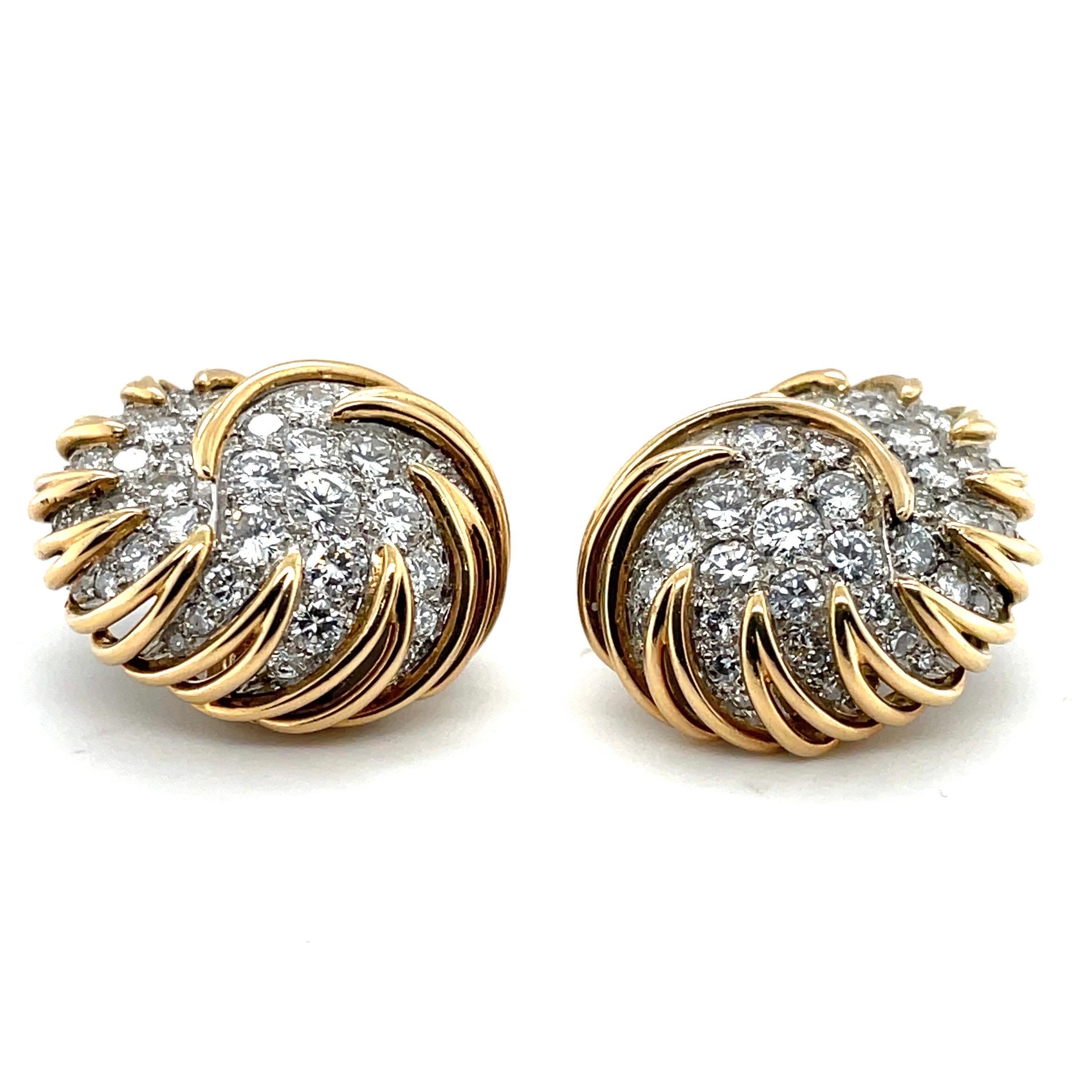 Charming 18 karat yellow gold and platinum diamond earclips, France, circa 1950s. 

Delightful earclips of slightly bombé, scroll design, each pavé-set with brilliant- and single-cut diamonds totalling circa 5.5 carats, within a platinum and 18