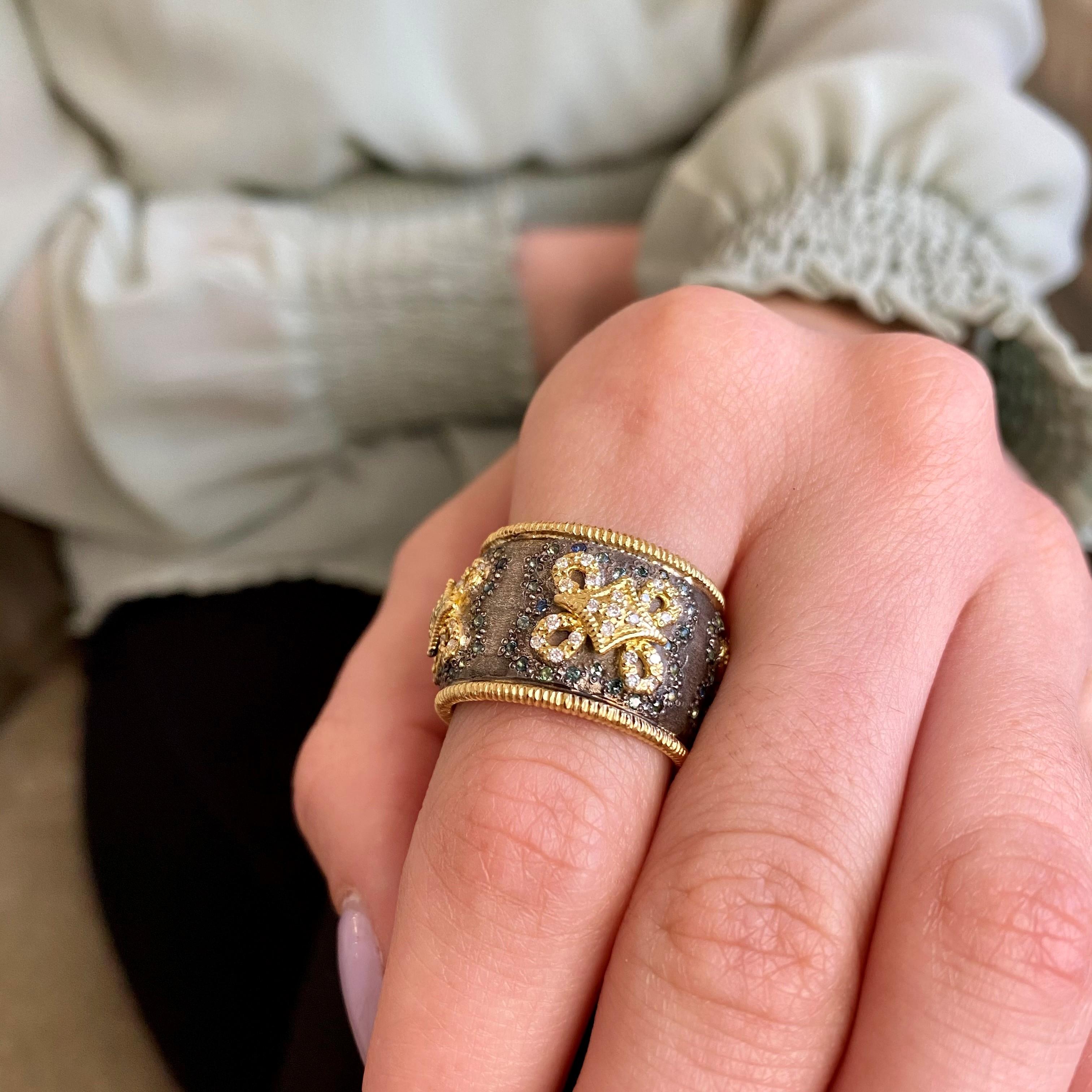 Old world wide ring hand crafted in 18 Karat Yellow Gold and grey oxidized silver. 
The blue-green tourmalines are set in the grey silver.
Diamonds are set in the yellow gold swirls. 
The wide cigar style band is accented on the top and bottom in