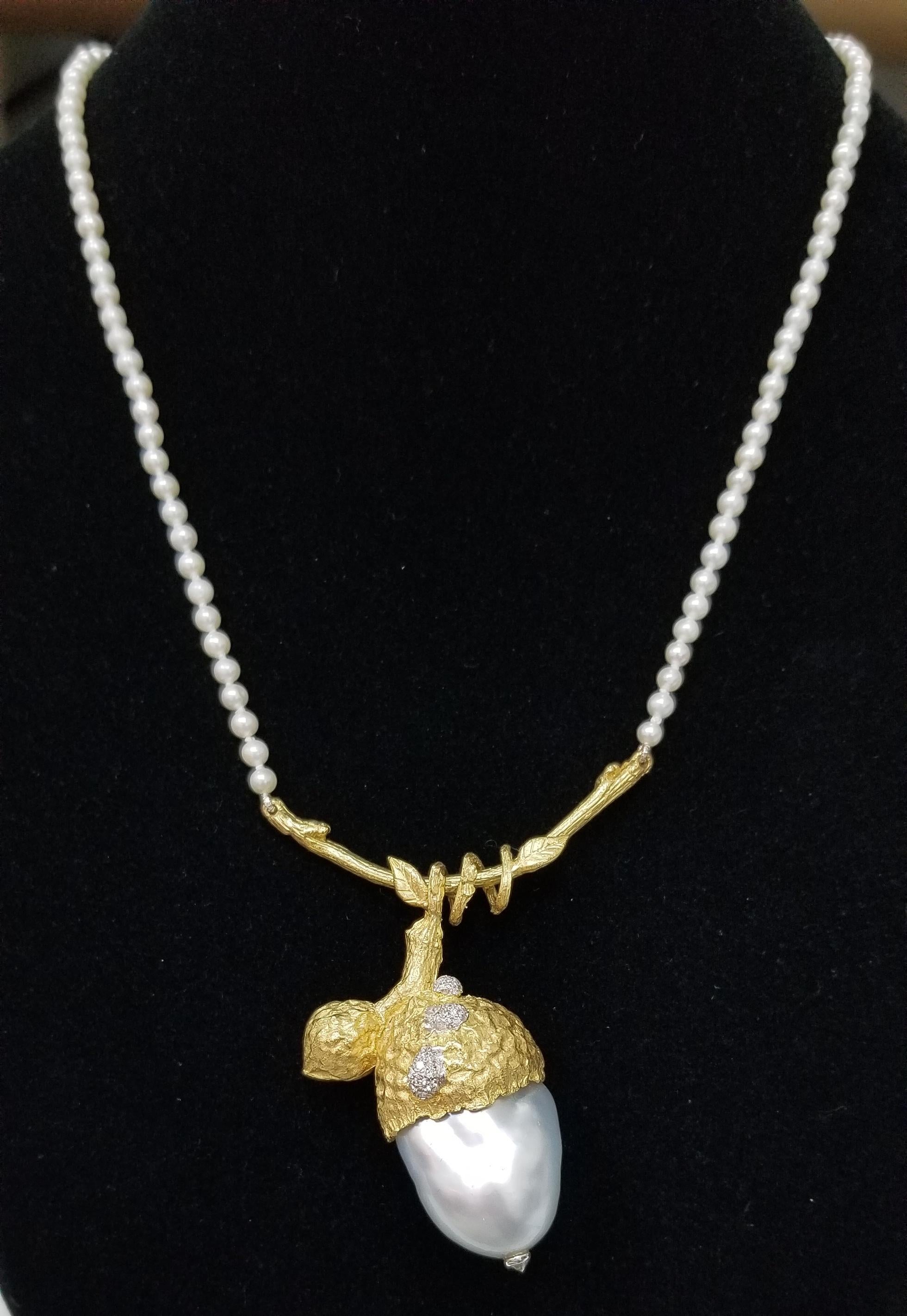 18k yellow gold and south sea biwa pearl pendant.  this piece is created to look like an accorn with a 25mm south sea biwa pearl with diamond accent as dew drops weighing .25pts. on a Gresha signature bark branch attached to 3mm pearl 16 inch