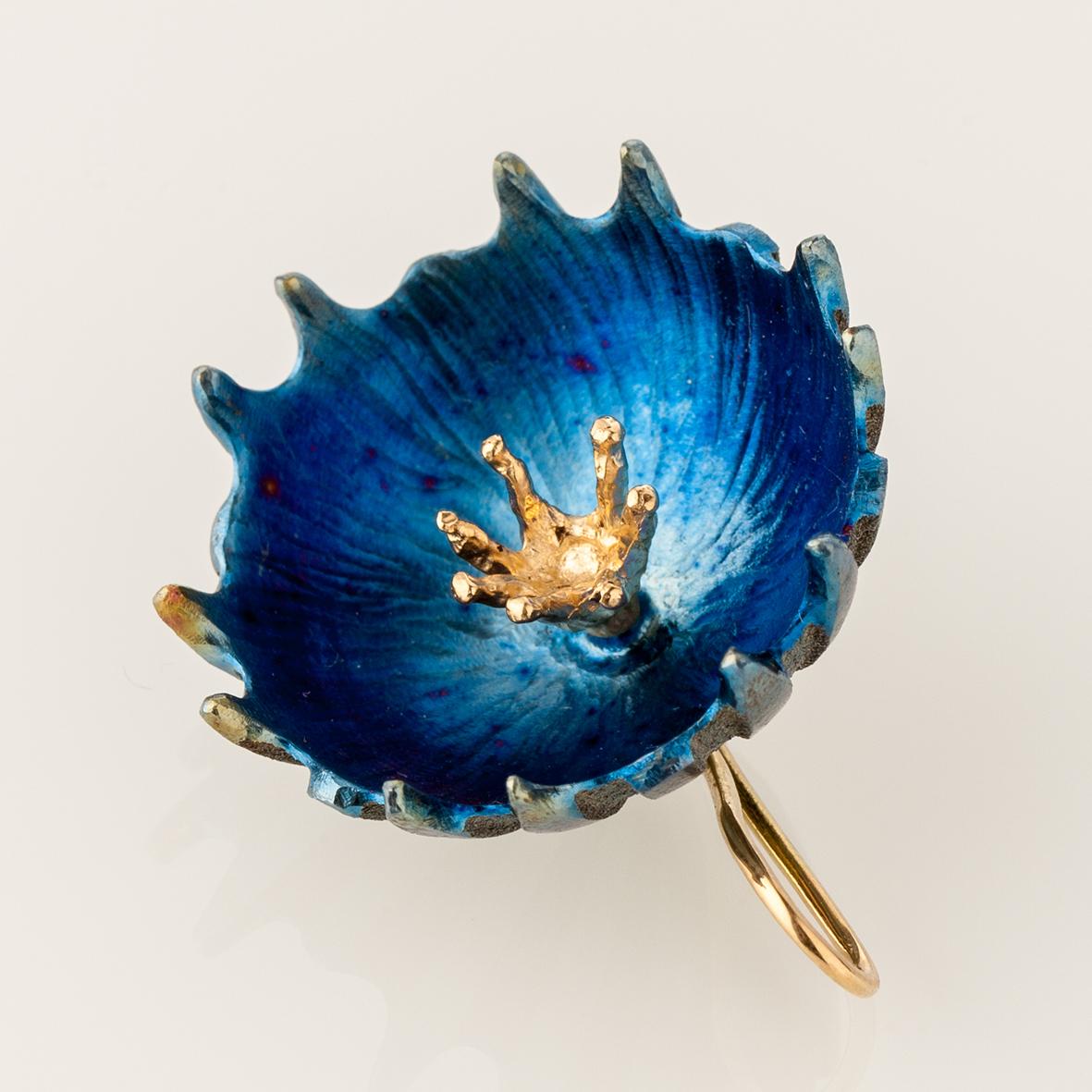 18-karat yellow gold and titanium pendant reminiscent of a cornflower ring is a luxurious and, at the same time, a playful accent of the style. 

This unique pendant tells about the woman who has exceptional taste and the one who does not forget to