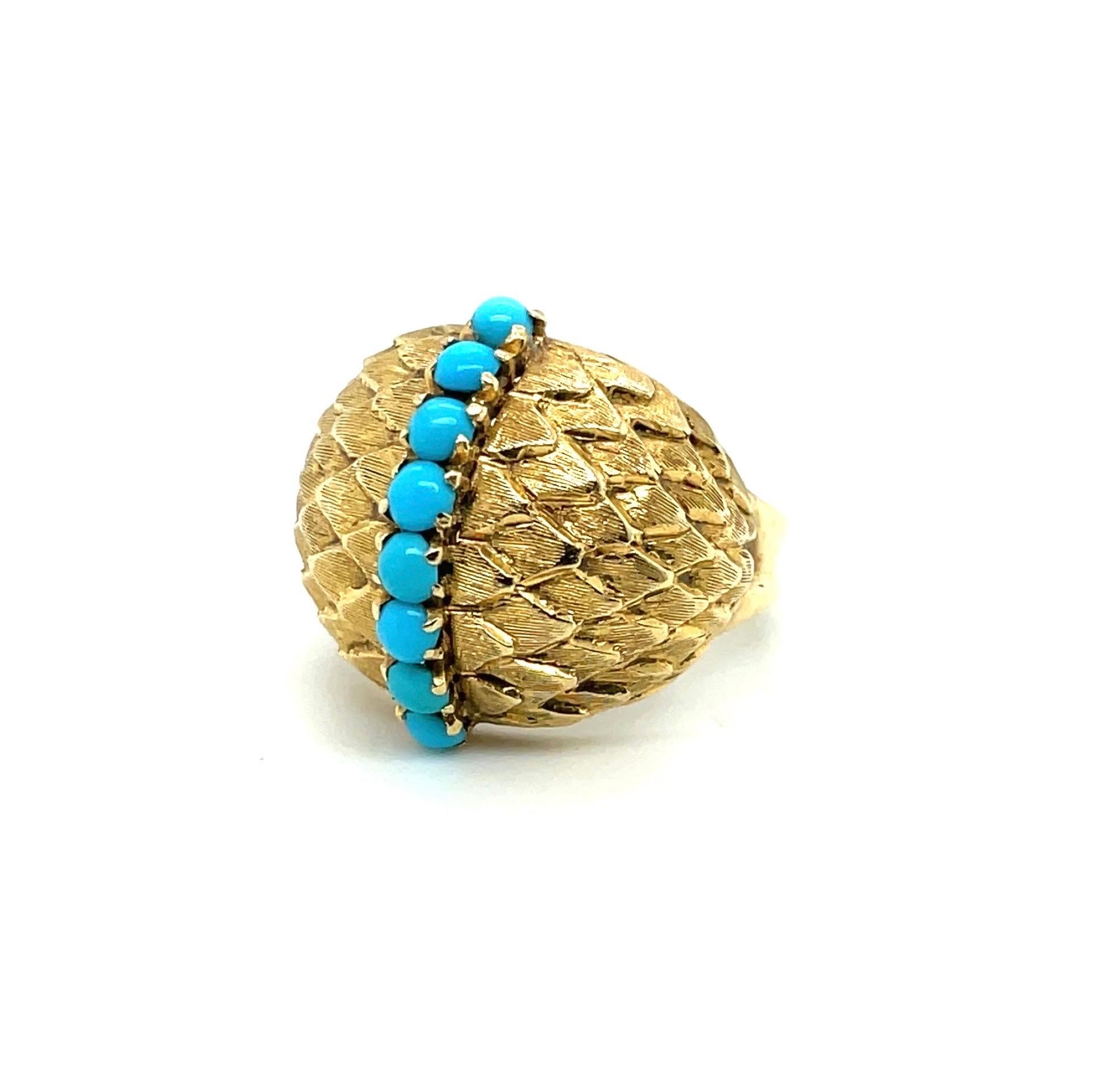Charming 18 karat yellow gold and turquoise Cocktail ring, circa 1950s. 

Of bombé design, crafted in 18 karat yellow gold and decorated with finely textured, matt-finish, stylised leaf motifs, centering upon a line of 8 round small turquoise