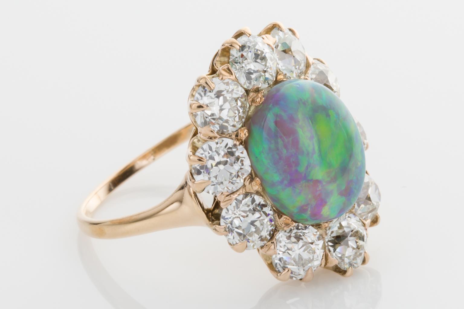 This is an exceptional antique opal ring, a burst of colour on your finger surrounded by the most gorgeous sparkly diamonds. Showcasing an Australian opal measuring 10.55 x 8.45 x 5.70mm, weighing approximately 2.65cts exhibiting the full colour