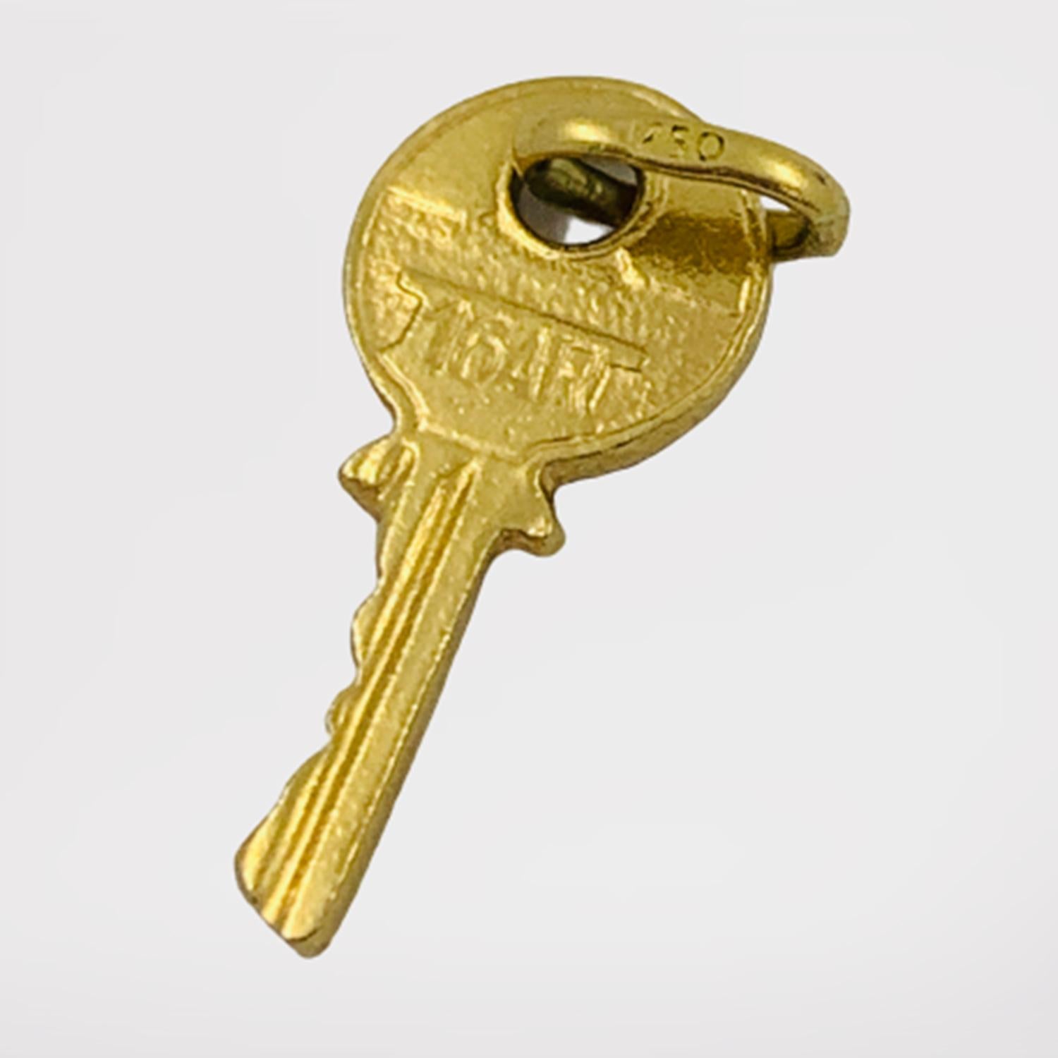 Vintage Key Shaped Charm Pendant Circa 1950-70's

Crafted of solid 18K yellow gold, this little charm will be the key to your heart. It's a perfect memory marker for first time home buyers, or your time living in a special home. The key is engraved