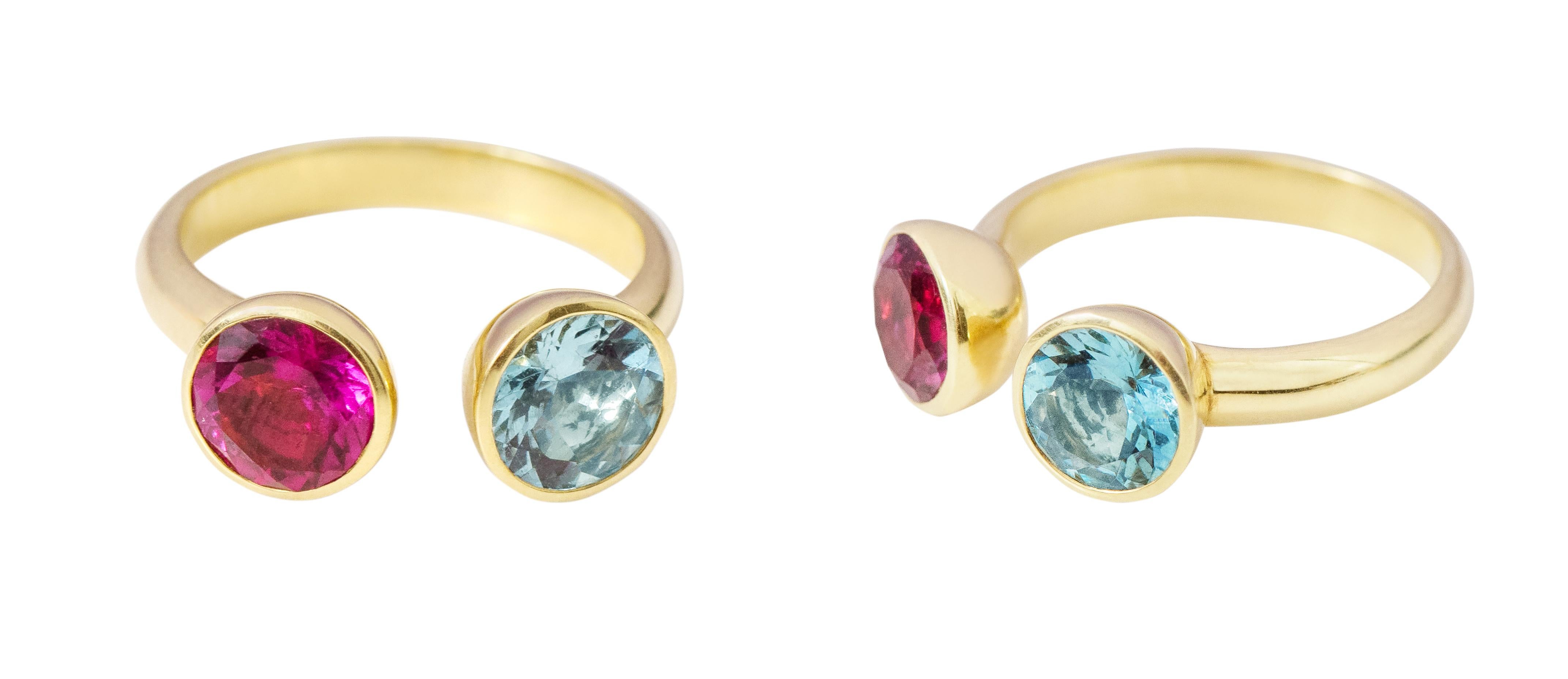 18 Karat Yellow Gold Aquamarine and Tourmaline Solitaire Ring

This distinctive vibrant magenta pink and electric blue tourmaline ring is blissful. The two solitaire brilliant round cut tourmalines in closed setting facing each other with the little