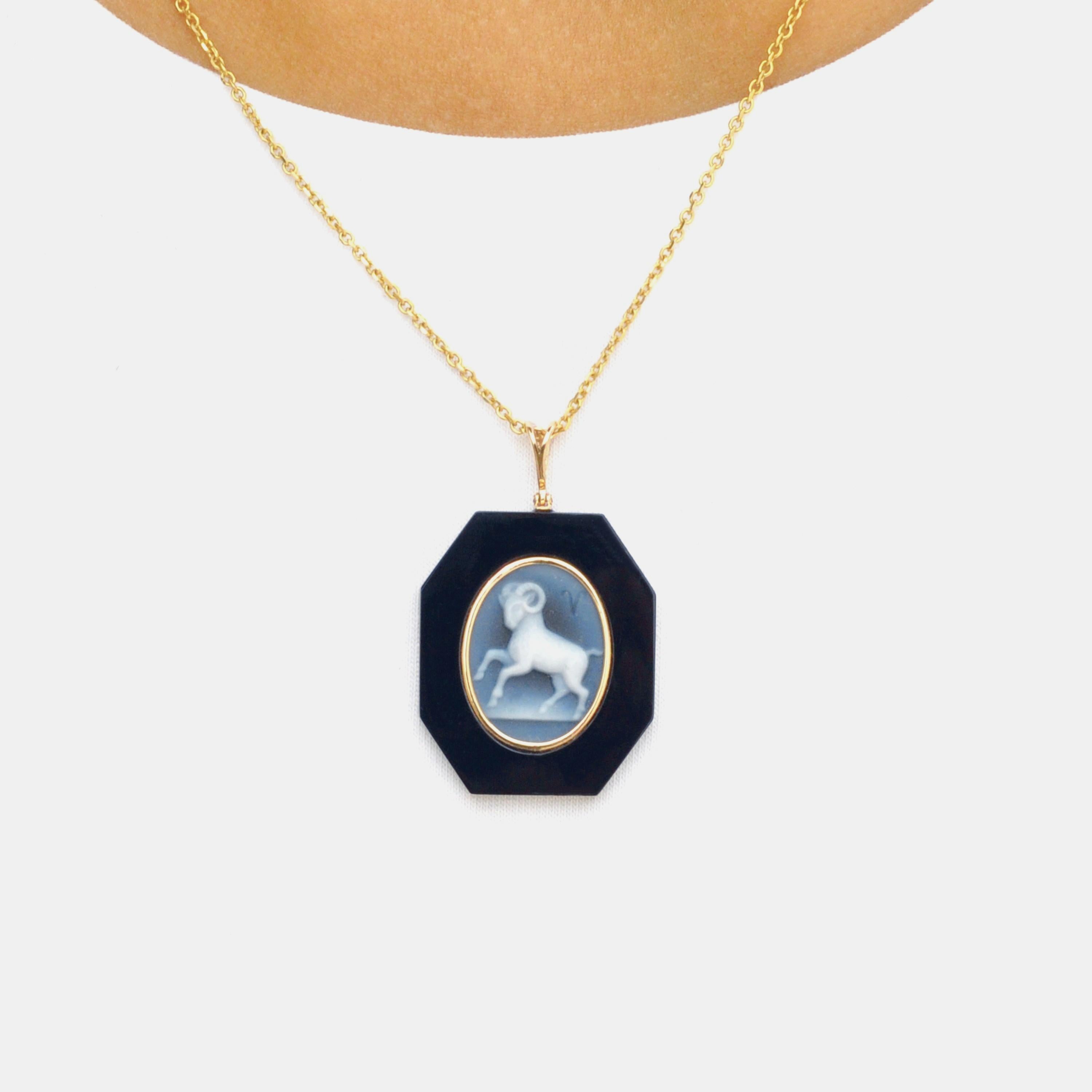 18 karat yellow gold aries zodiac agate cameo black onyx pendant necklace. 

This exquisite pendant showcases a stunning combination of contemporary design and timeless elegance. Crafted in 18K gold, the piece features a sleek loop from which