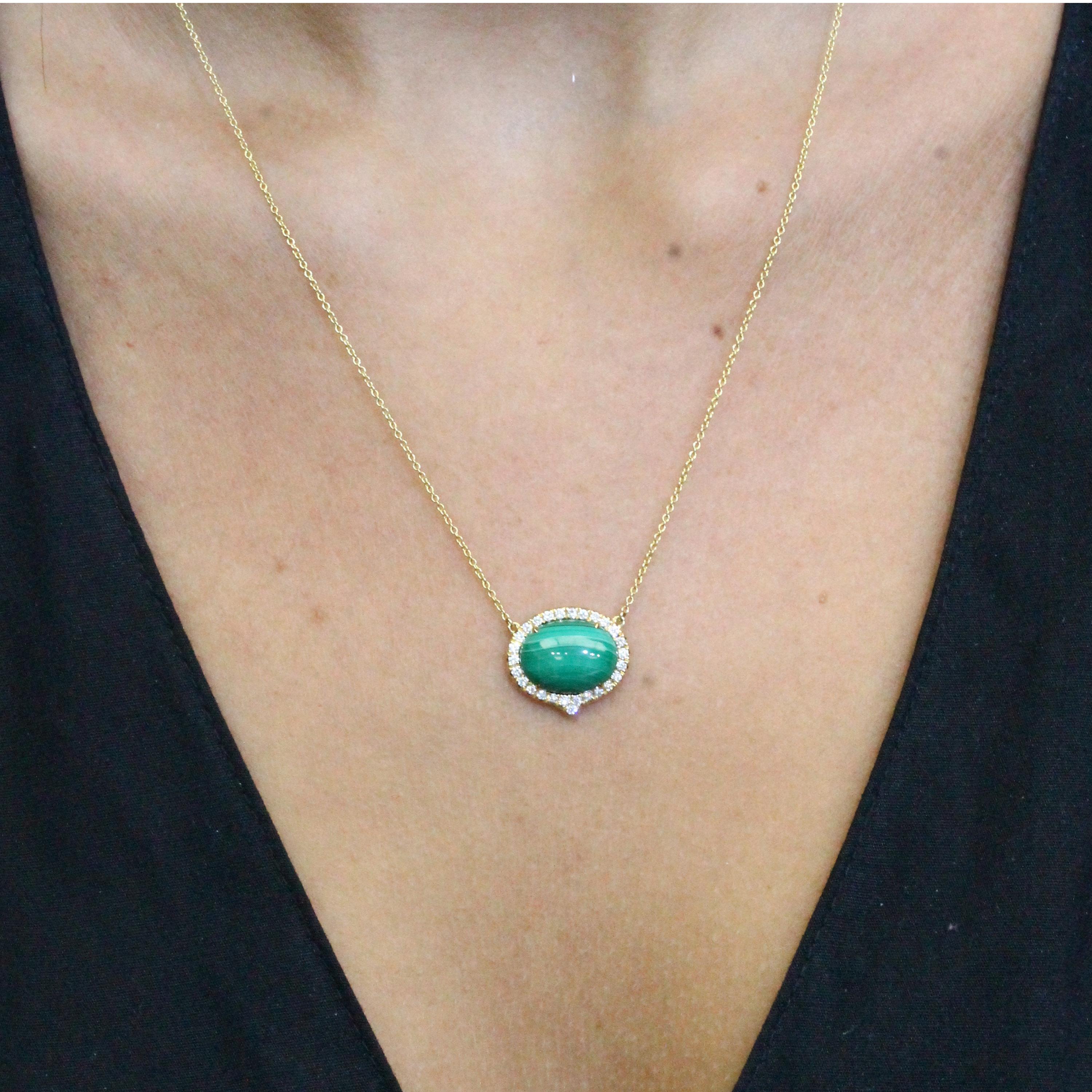 Art-Deco style Necklace featuring East-West Oval Cabochon Malachite, and diamond halo set in 18K yellow gold, hanging on an 18-inch Chain with 16-inch adjuster. Malachite is stone of balance and abundance, and often called 