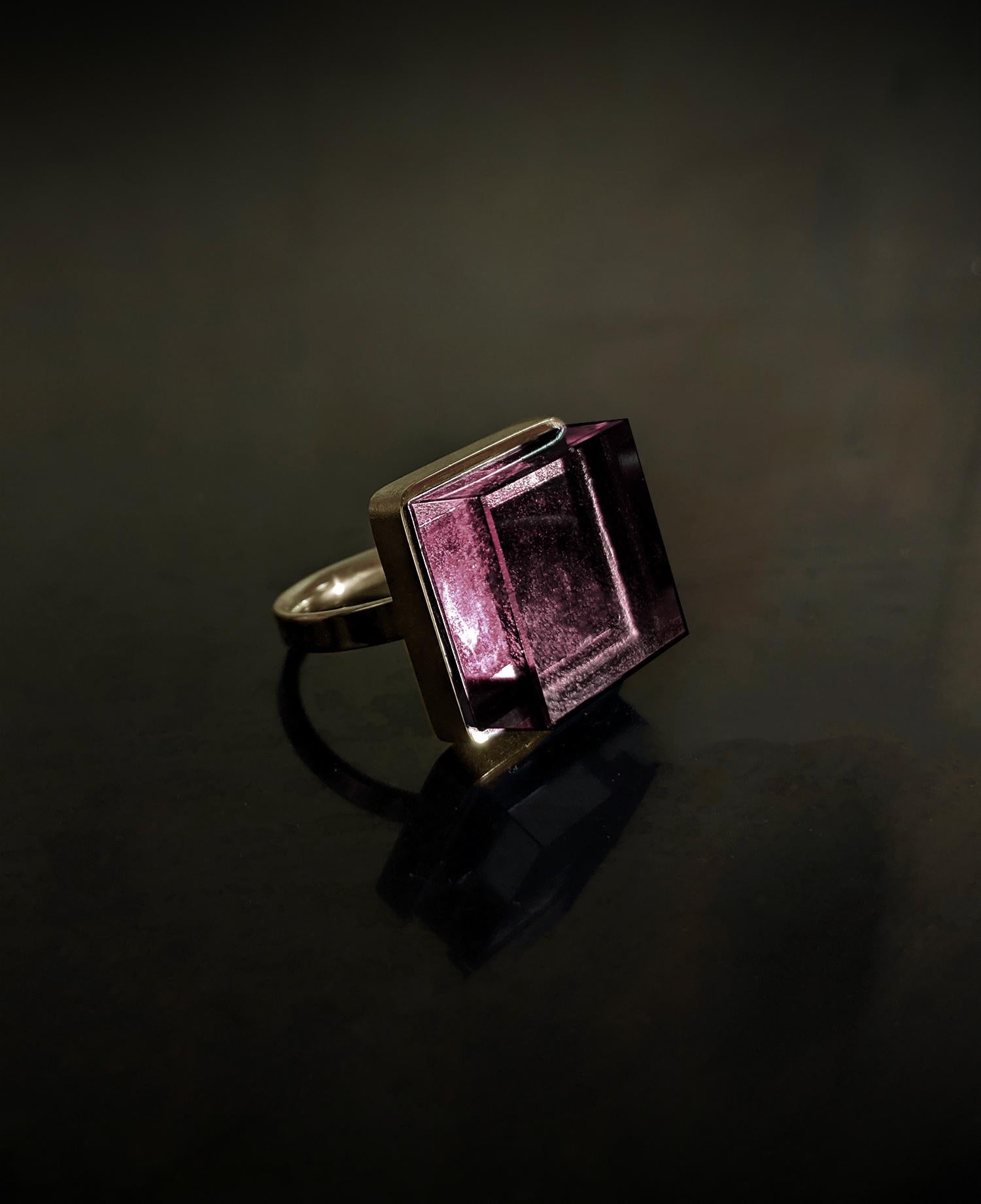 This Art Deco style ring features a 15x15x8 mm natural pink tourmaline set in 18 karat yellow gold. It has been featured in both Harper's Bazaar and Vogue UA.

Its design is inspiring to architects, designers, and artists alike. The ring's size and