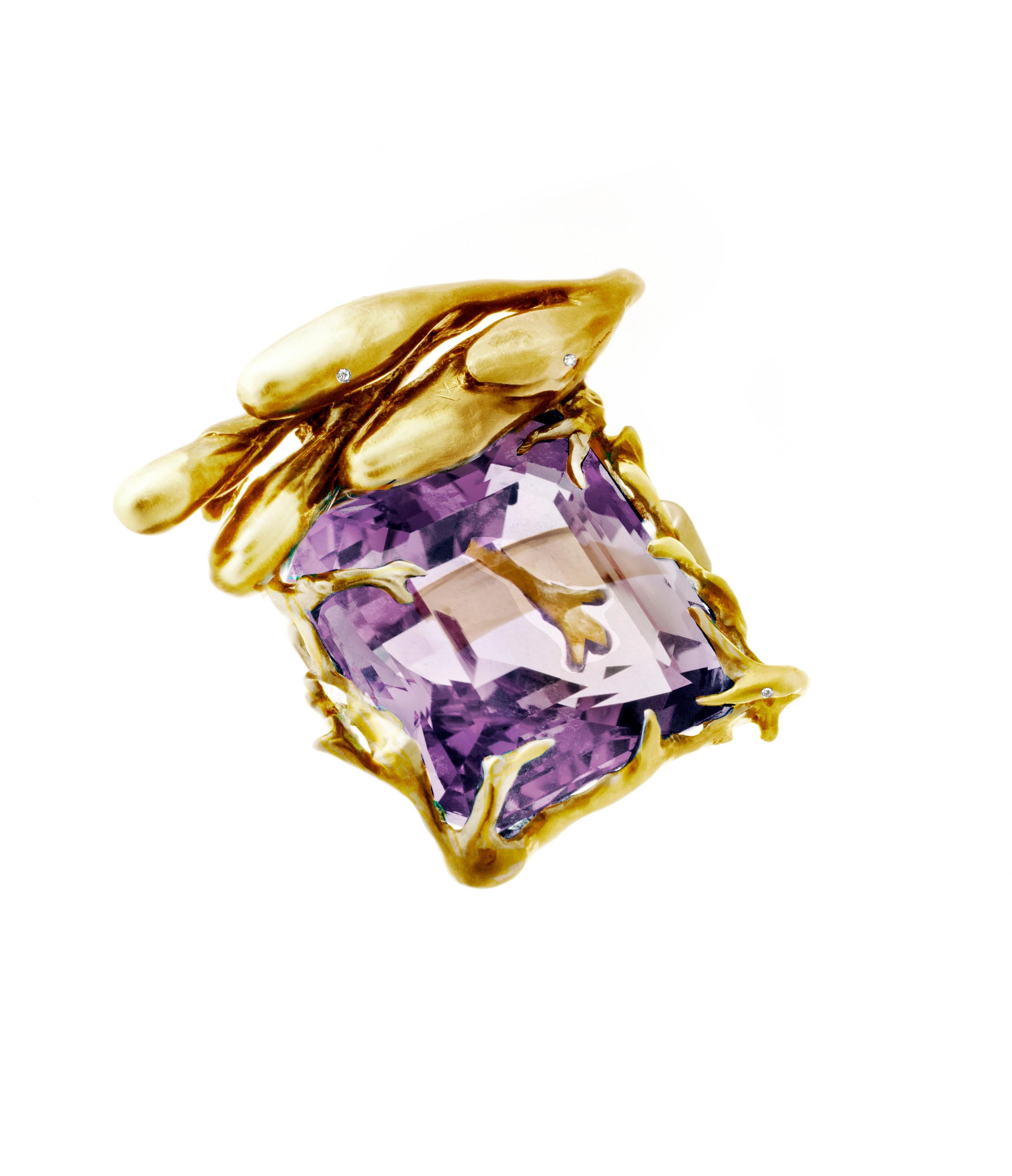 This Fairy Tale engagement ring is a contemporary masterpiece designed by oil painter Polya Medvedeva. It is crafted from 18 karat yellow gold and features an antique cushion cut amethyst that radiates vivid lavender tones. The ring is adorned with