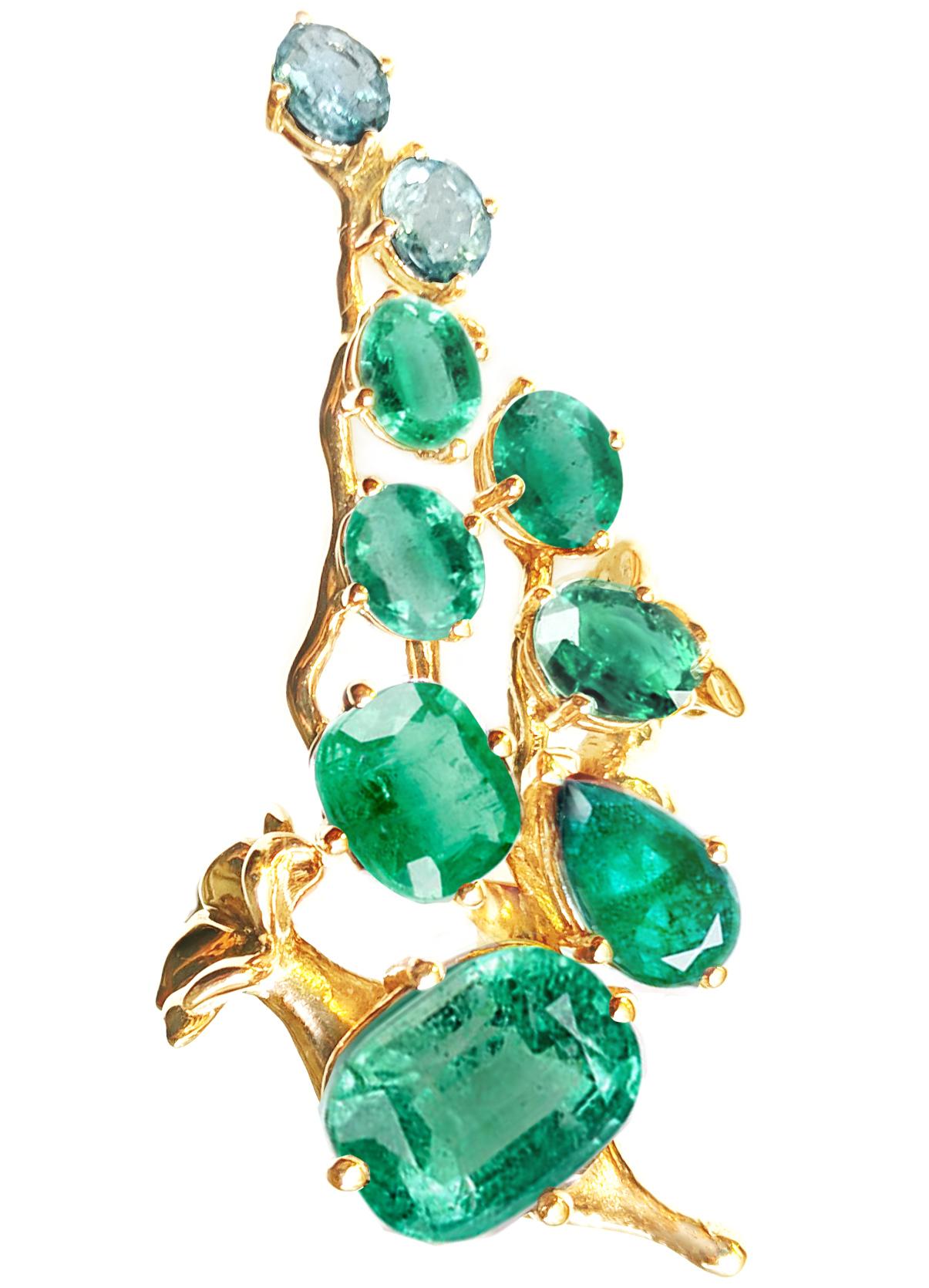 This Tobacco Flower contemporary floral brooch is made of 18 karat yellow gold. The natural gems in this piece include a cushion cut emerald of 3.48 carats (10.5x9 mm) and another of 1.37 carats (8.4x6 mm), a pear cut emerald of 0.98 carats (8.5x5.2