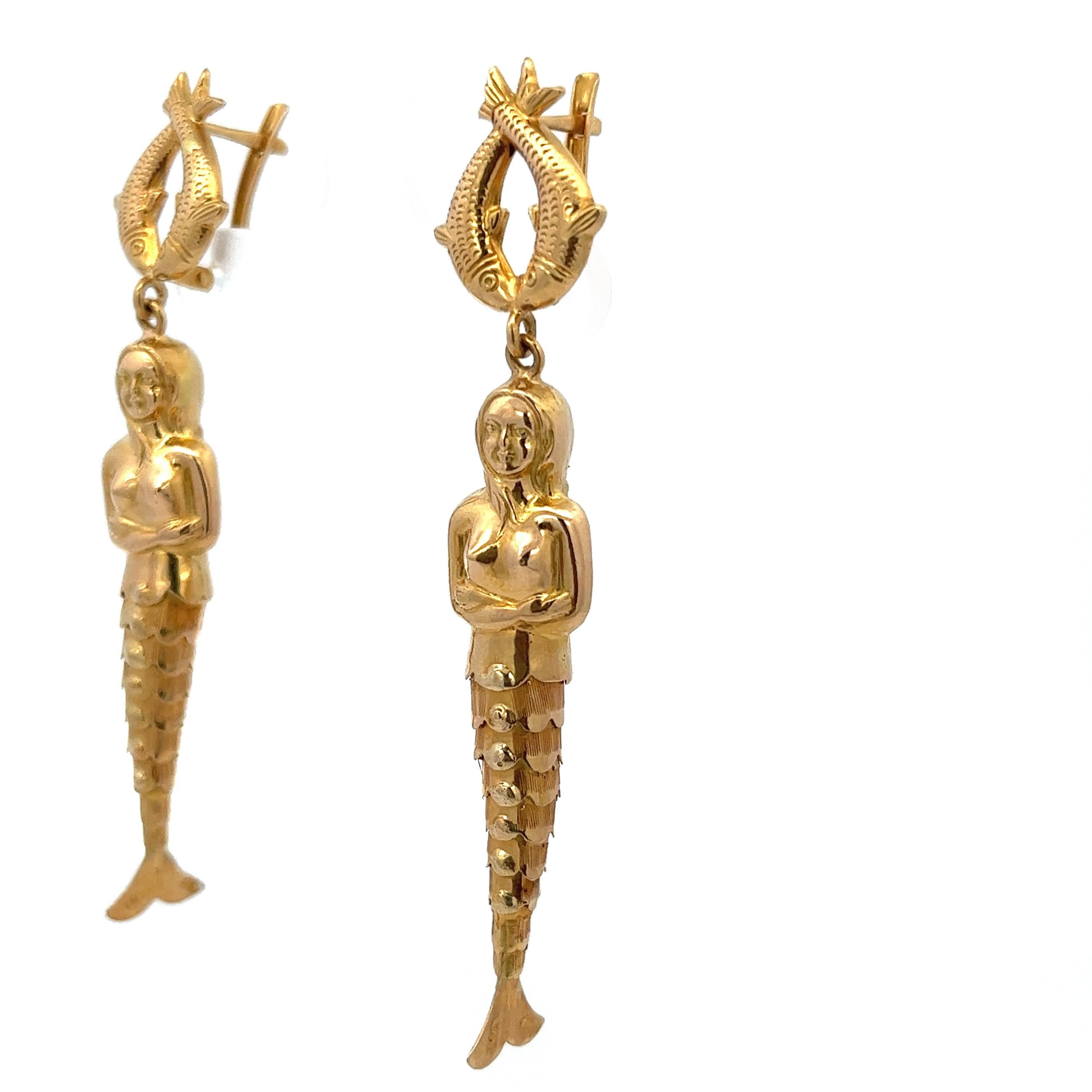 18 Karat Yellow Gold Articulated Mermaid Earrings 

These beauties are certainly one of a kind - nearly mythological! 
intricately sculpted features accenting an articulated fish tail. 
Similar to the highly in demand fish charm, these earrings will