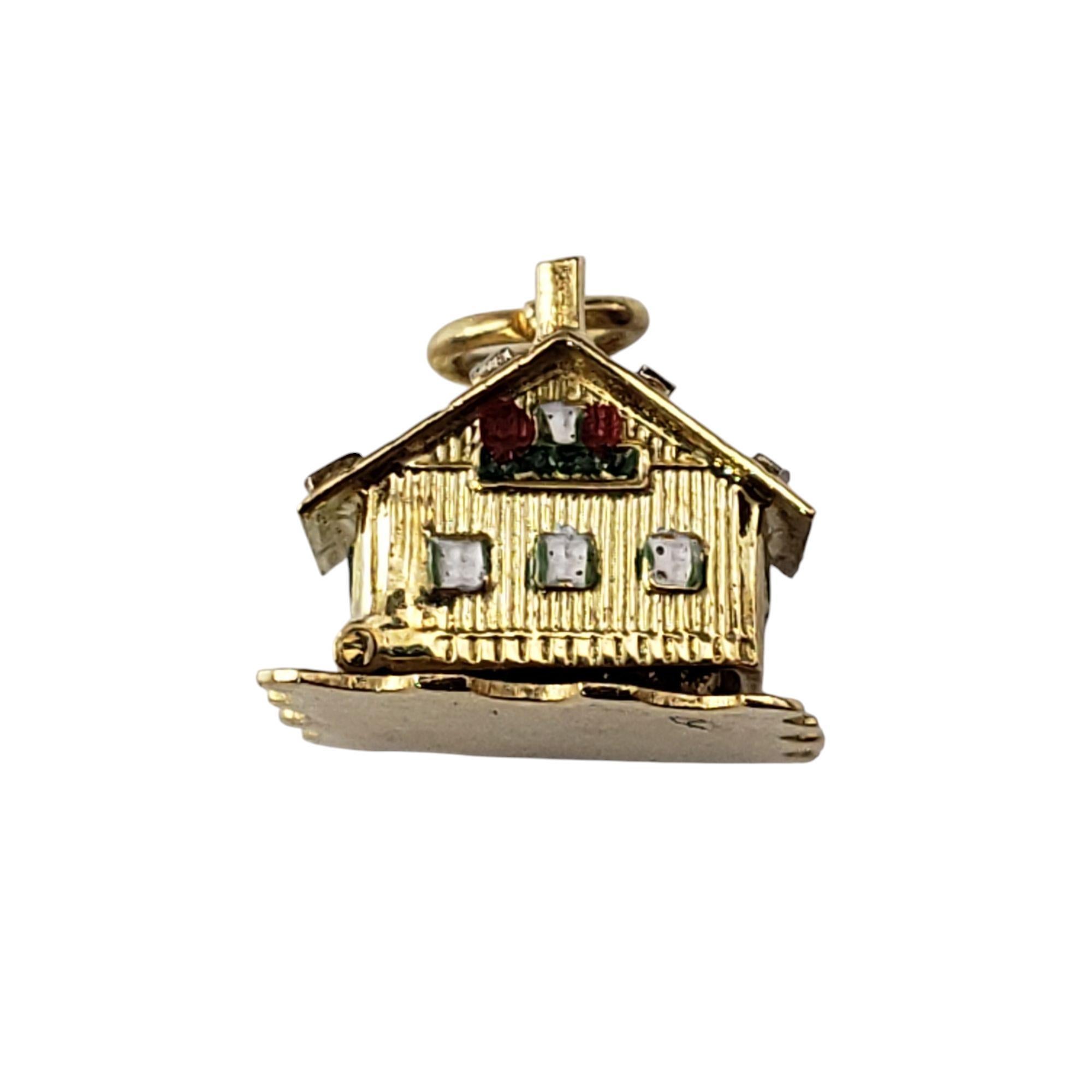 18K Yellow Gold Articulated Swiss Chalet Charm-

This delightful 18K yellow gold charm is a miniature masterpiece, capturing the charm of an alpine retreat with a playful secret inside. Designed with intricate details, the chalet opens to reveal a