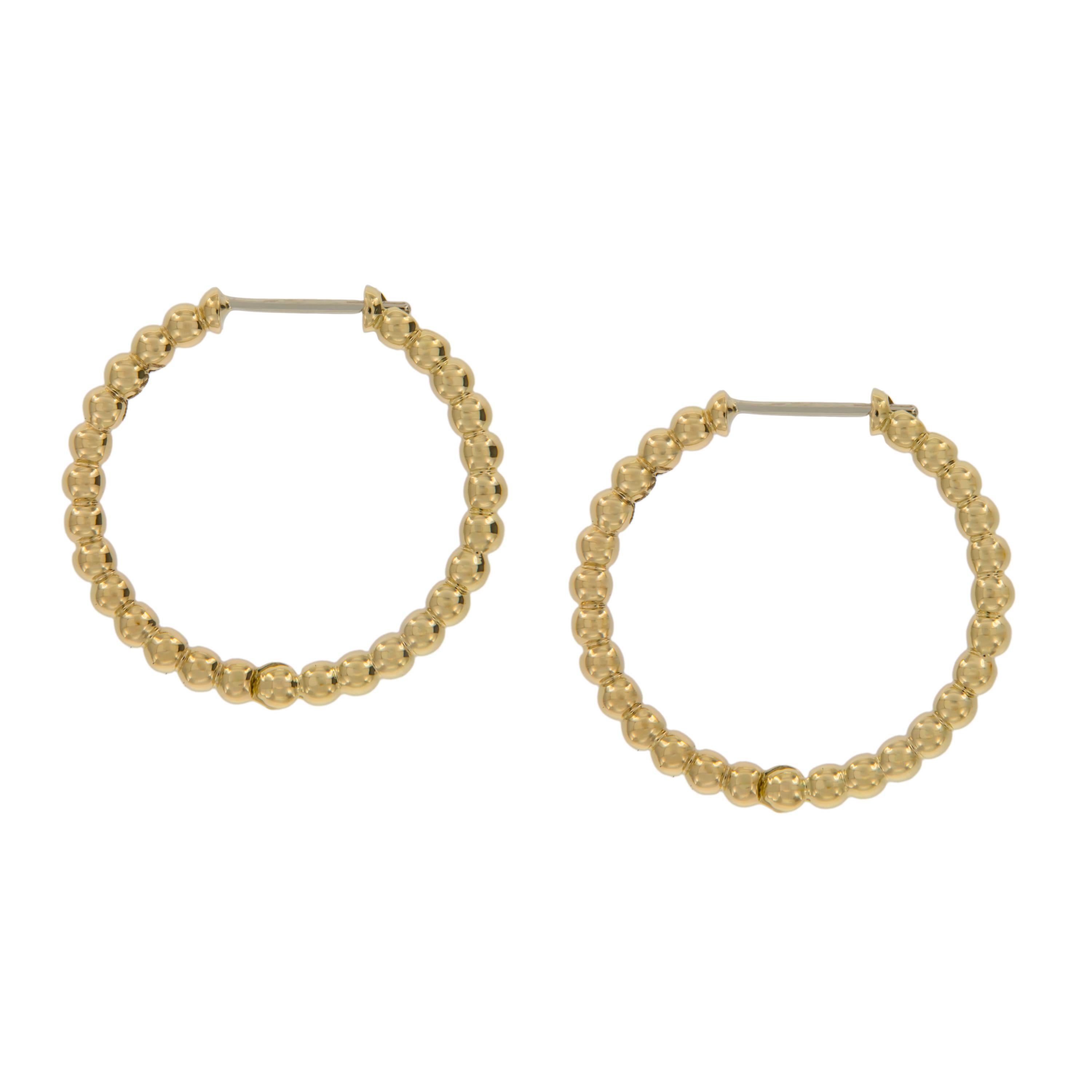 There is nothing more classic than these hoop earrings beautifully accented with gold ball 