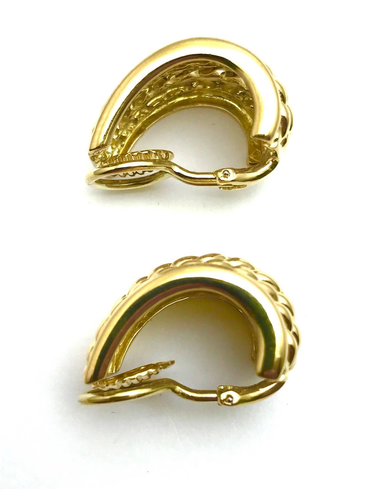 A pair of 18 karat yellow gold basket weave drop clip-on earrings.  The earrings are domed towards the bottom and taper toward the top of the ear.  (A Post can be added)

Hallmark:  18K