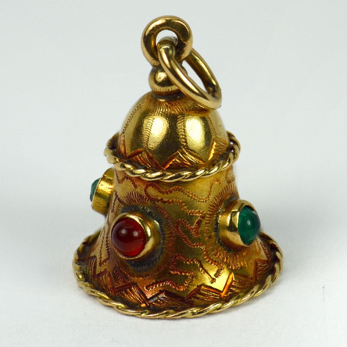 An 18 karat (18K) yellow gold charm pendant designed as a bell set with paste cabochons (one damaged). Stamped with the owl mark for French import and 18 karat gold.

Dimensions: 1.9 x 1.4 x 1.4 cm (not including jump ring)
Weight: 2.95 grams
