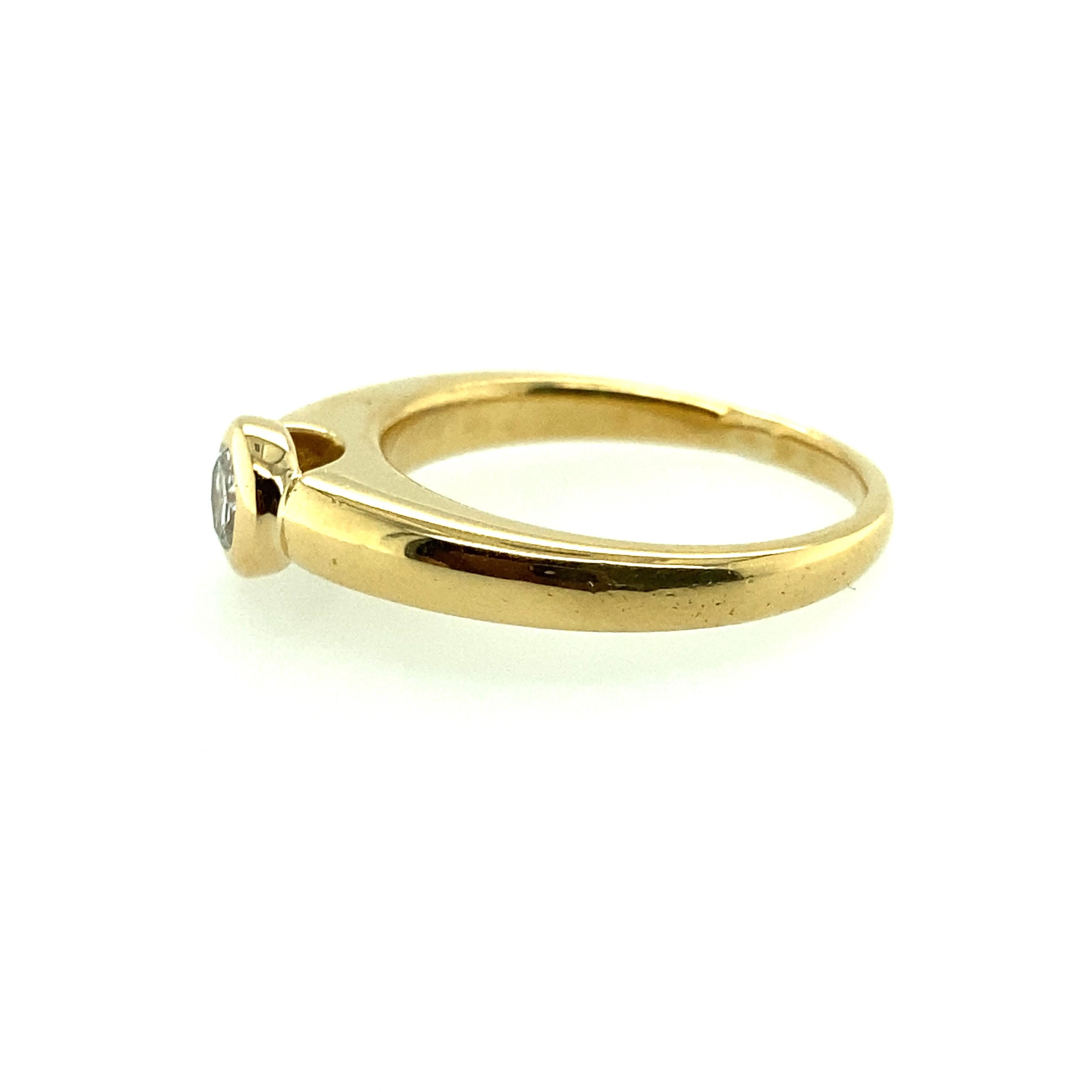 Modern 18 Karat Yellow Gold Bezel Set Diamond Engagement Ring For Sale