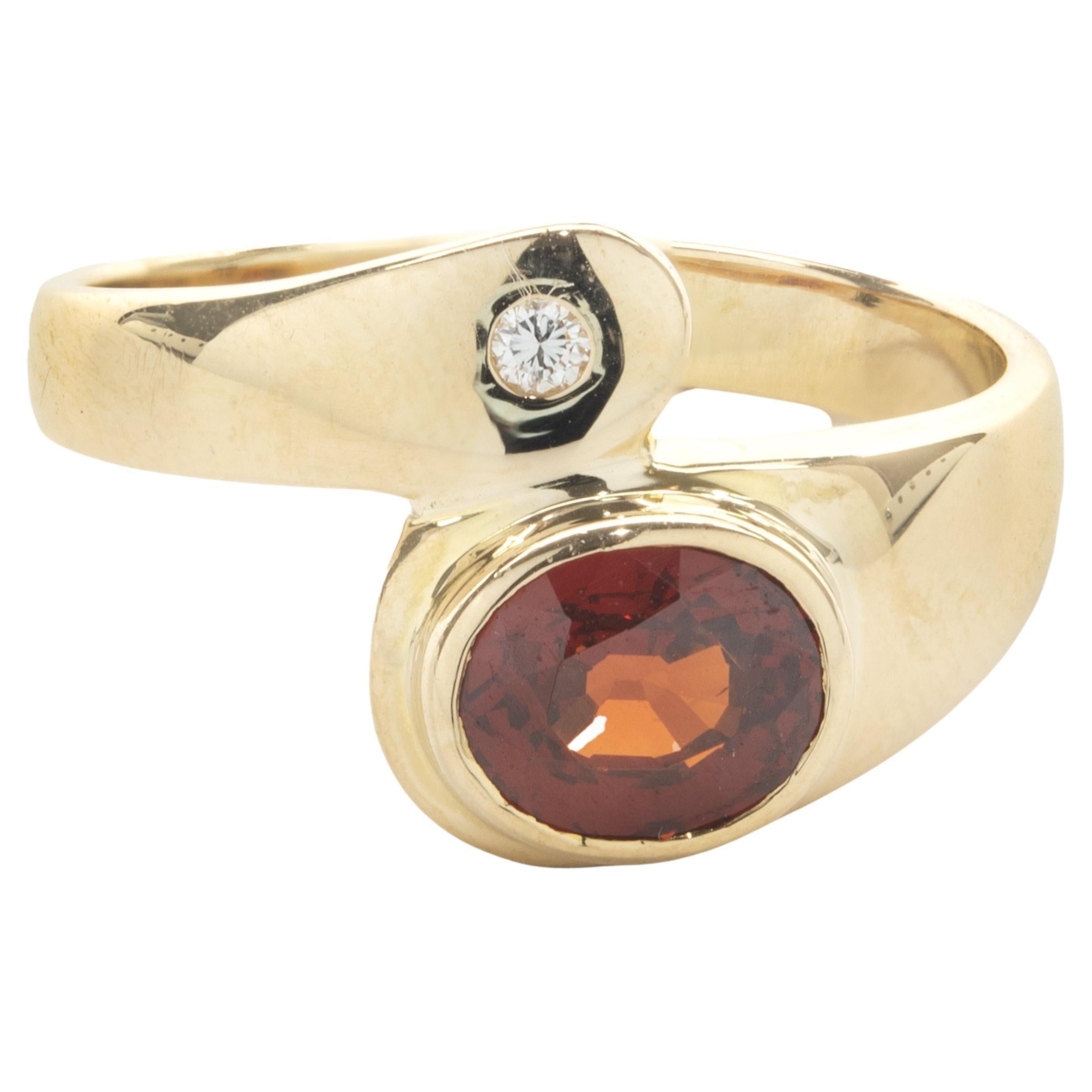 18 Karat Yellow Gold Bezel Set Garnet and Diamond Bypass Ring