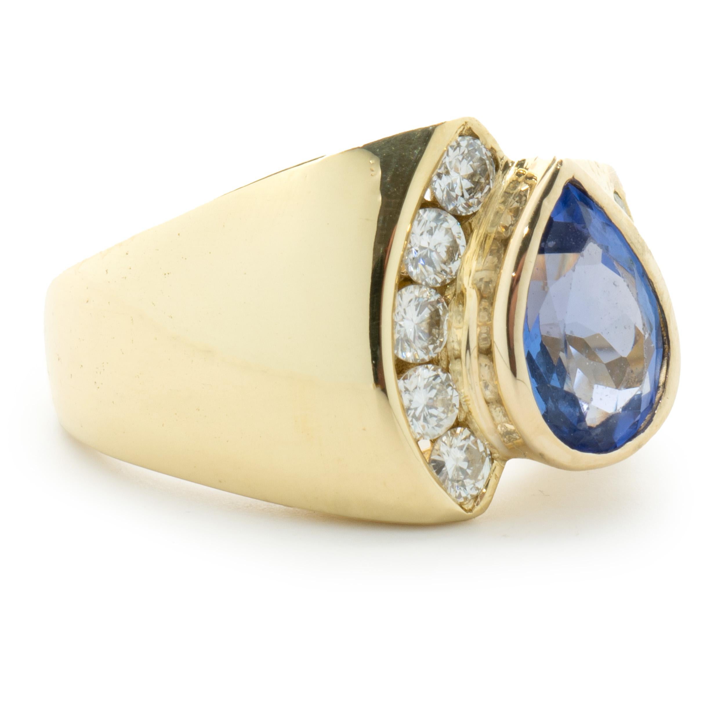 Designer: custom design
Material: 18K yellow gold
Tanzanite: 1 pear cut = 1.23ct
Diamond: 10 round brilliant cut = 0.40cttw
Color: G
Clarity: SI1
Dimensions: ring top measures 13mm wide
Ring Size: 5 (please allow two extra shipping days for sizing