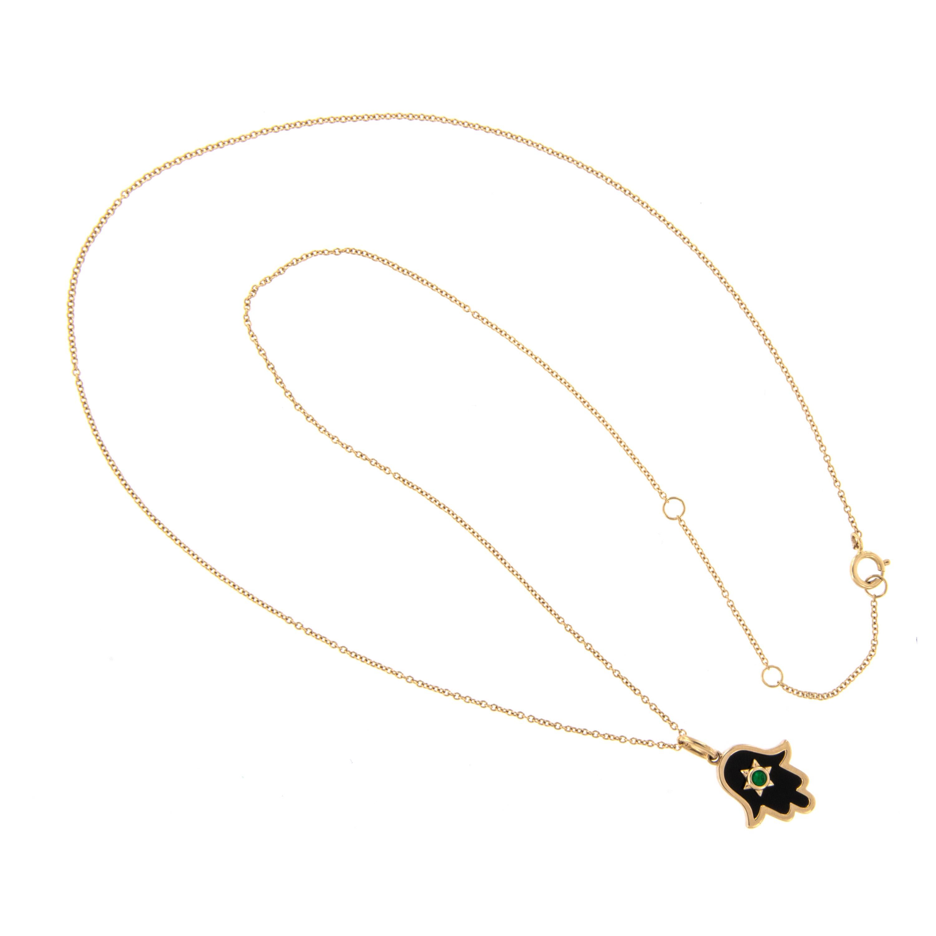 Made from rich 18 karat yellow gold with striking black onyx and emerald 