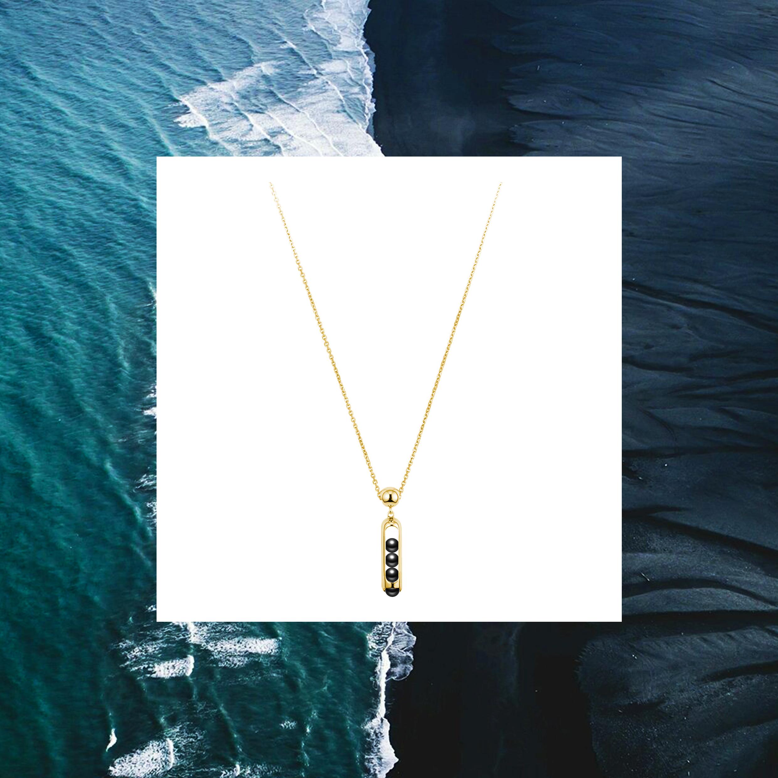 This unisex Melody pendant necklace combines perfect hand carved black Onyx beads that roll within their 18 karat gold. Gold award winning Melody collection is a clever design solution.  Each piece incorporates a unique movement mechanism so that