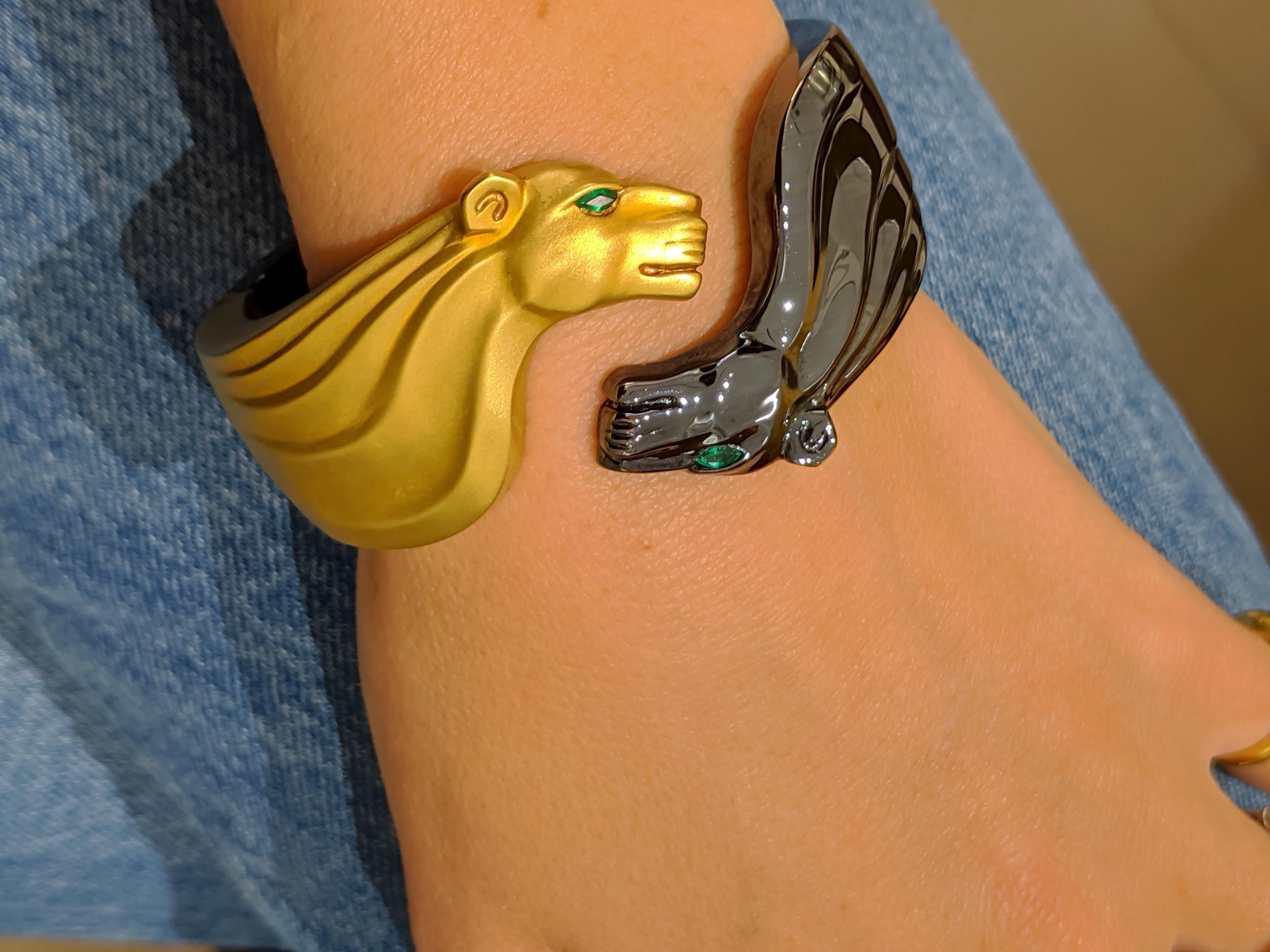 Yin Yang Panther Cuff Bracelet
One panther is crafted in 18 karat yellow gold with a satin finish, the other in sterling silver with a blackened finish. Each panther has a marquis cut Emerald eye. The bracelet is hinged allowing it to be put on