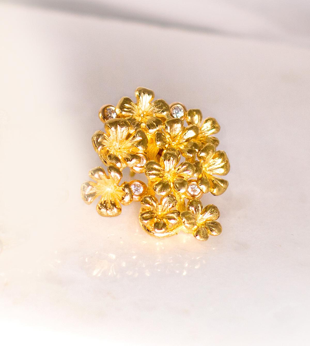 This Plum Blossom Sculptural brooch is in 18 karat yellow gold with 5 round diamonds. This collection was featured in Vogue UA review. We use top natural diamonds VS, F-G, and work with a German gems company that has been in the market since the