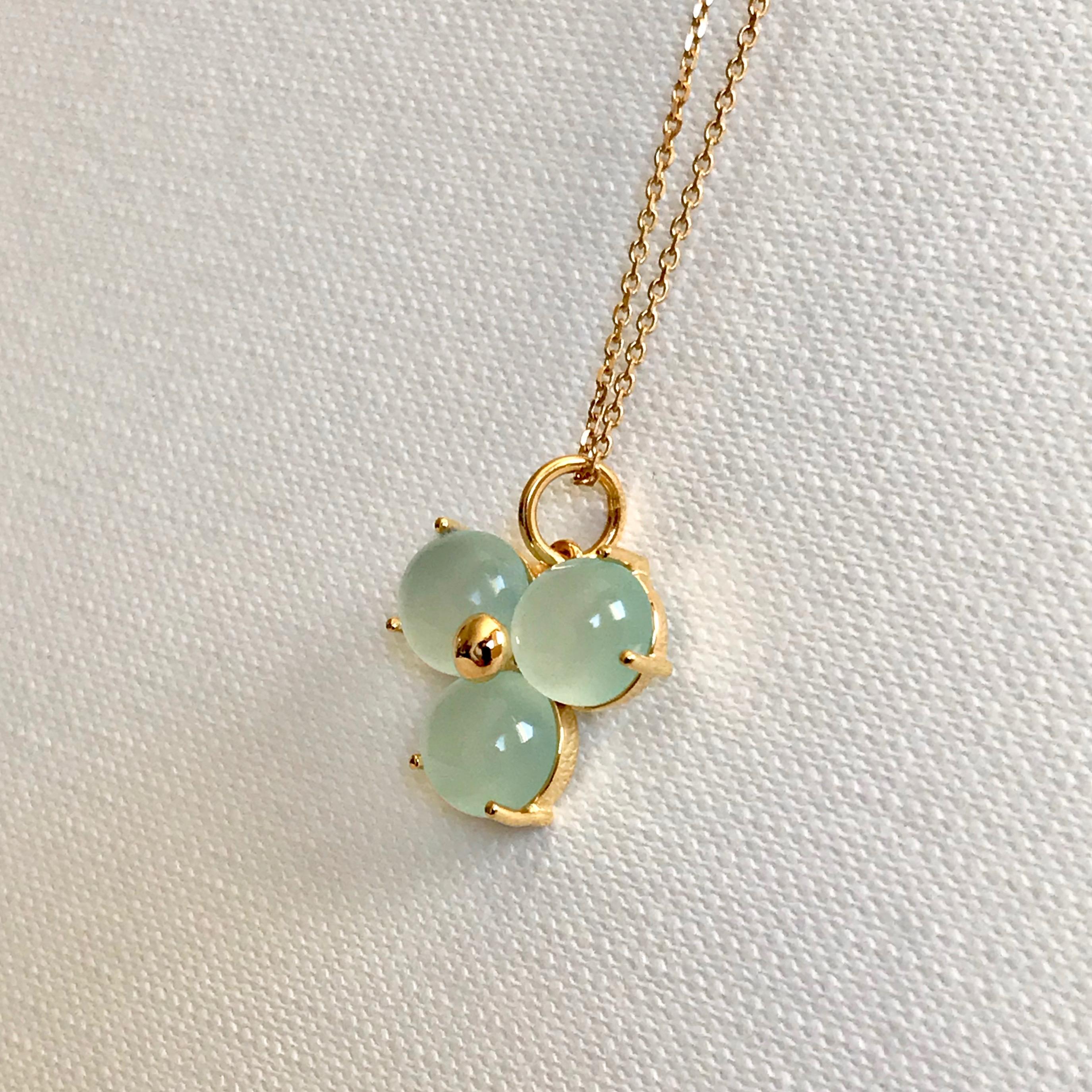 Handmade Solid 18 Karat yellow gold blossom pendant necklace with light blue round cabochon cut stones.
The chain can be used with other pendants or just by itself. 
Hallmark: London Goldsmiths’ Company – Assay Office
Pendant's