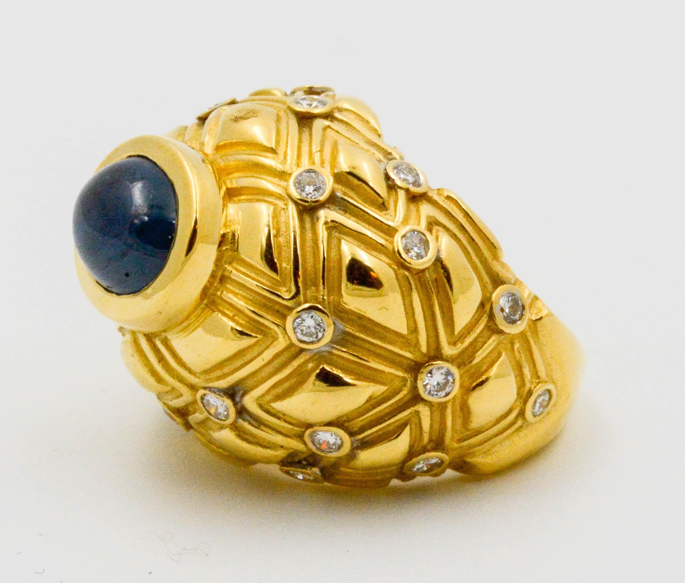 An exquisite 18 karat yellow Circa 1980's basketweave ring set with a 4 carat cabochon cut blue Sapphire and accented with  24 round brilliant cut .75 carats diamonds (G-H color, VS internal clarity). Ring is currently a finger size 5.