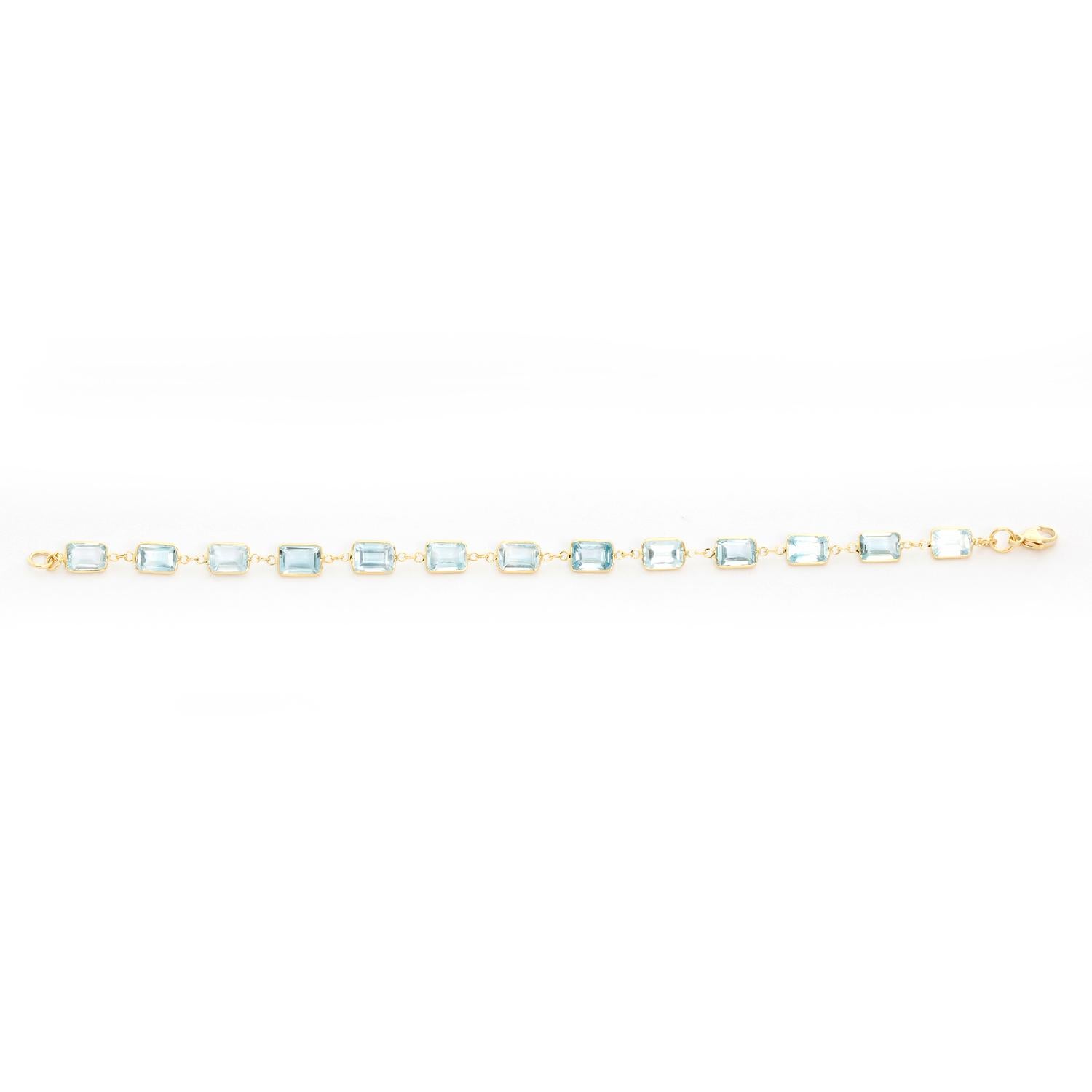 18K Yellow Gold Blue Topaz Bracelet - 13 gorgeous light blue topaz baguettes are housed on an 18k yellow gold bracelet and separated by 3 round links. Bracelet measures 6 3/4 inches. New with DeMesy box. .