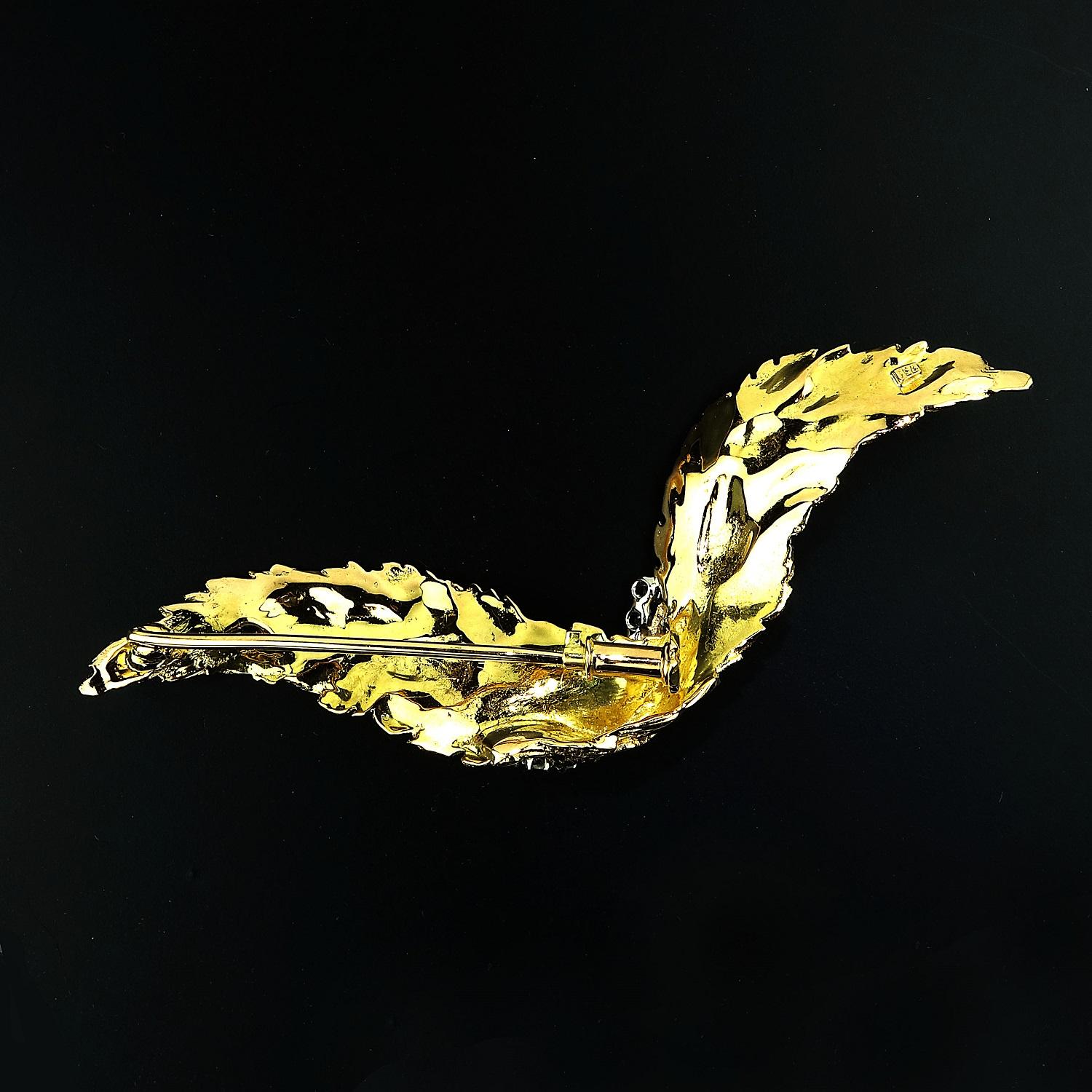 Lovely, handmade 18K Yellow Gold and Diamond Leaf Motif Brooch that measures 3.5 inches in length. The design of this brooch has a distinctive fold that features ten diamonds and creates a wavy effect.  This unique beautiful brooch can sit