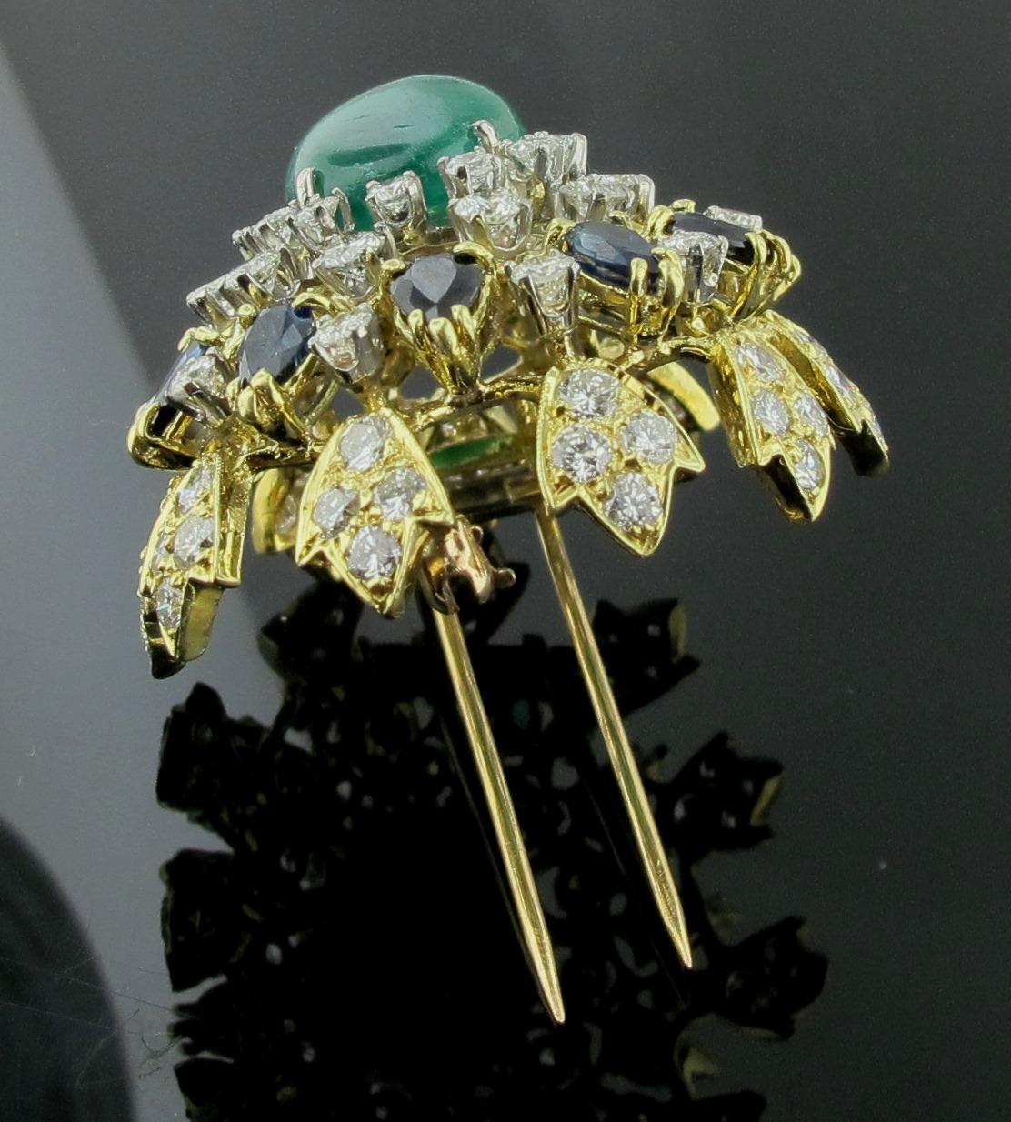 Round Cut 18 Karat Yellow Gold Brooch with Diamonds, Sapphires and a Cab Emerald Center For Sale