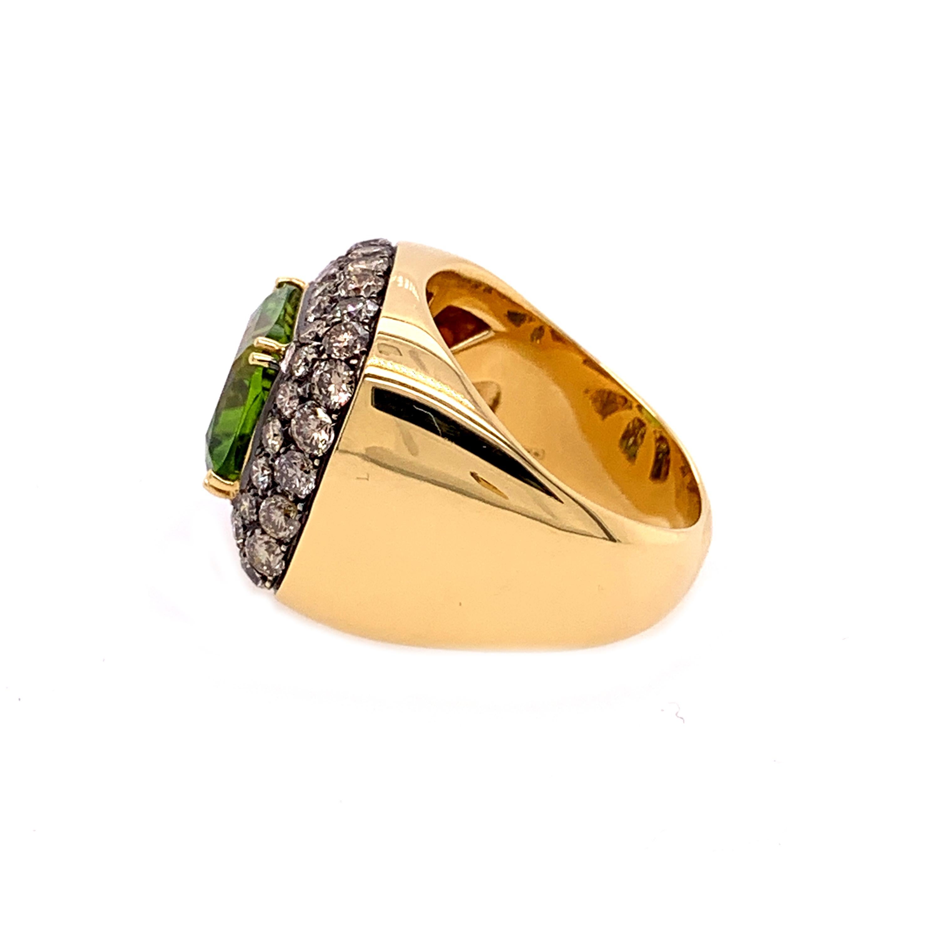 18 Karat Yellow Gold Brown Diamonds  and  Peridot Ring, finger size 54.5
18kt White gold   gr: 15.80
Brown Diamonds ct 0.54
A beautiful   square cut peridot of ct 10.40, surronded by a pillow of brown diamonds.
Matching earrings also available upon