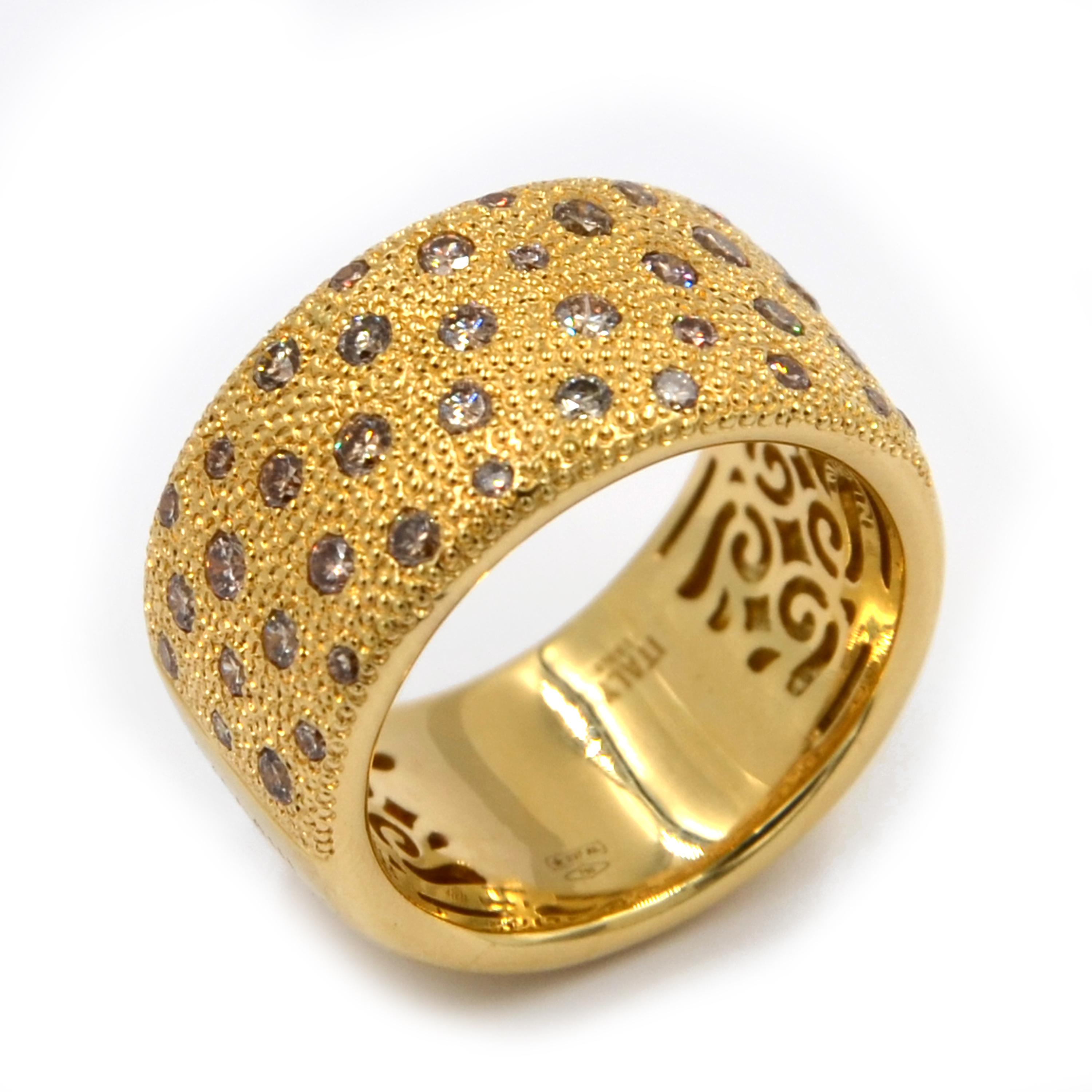 18 Karat Yellow Gold Brown Diamonds  GARAVELLI Band Ring , set in an artisanal scattered way, with hand hammered gold surface among the brown diamonds.
Finger size 55
The ring width is mm 12
18kt GOLD gr : 16,20
BROWN DIAMONDS ct : 0,96
