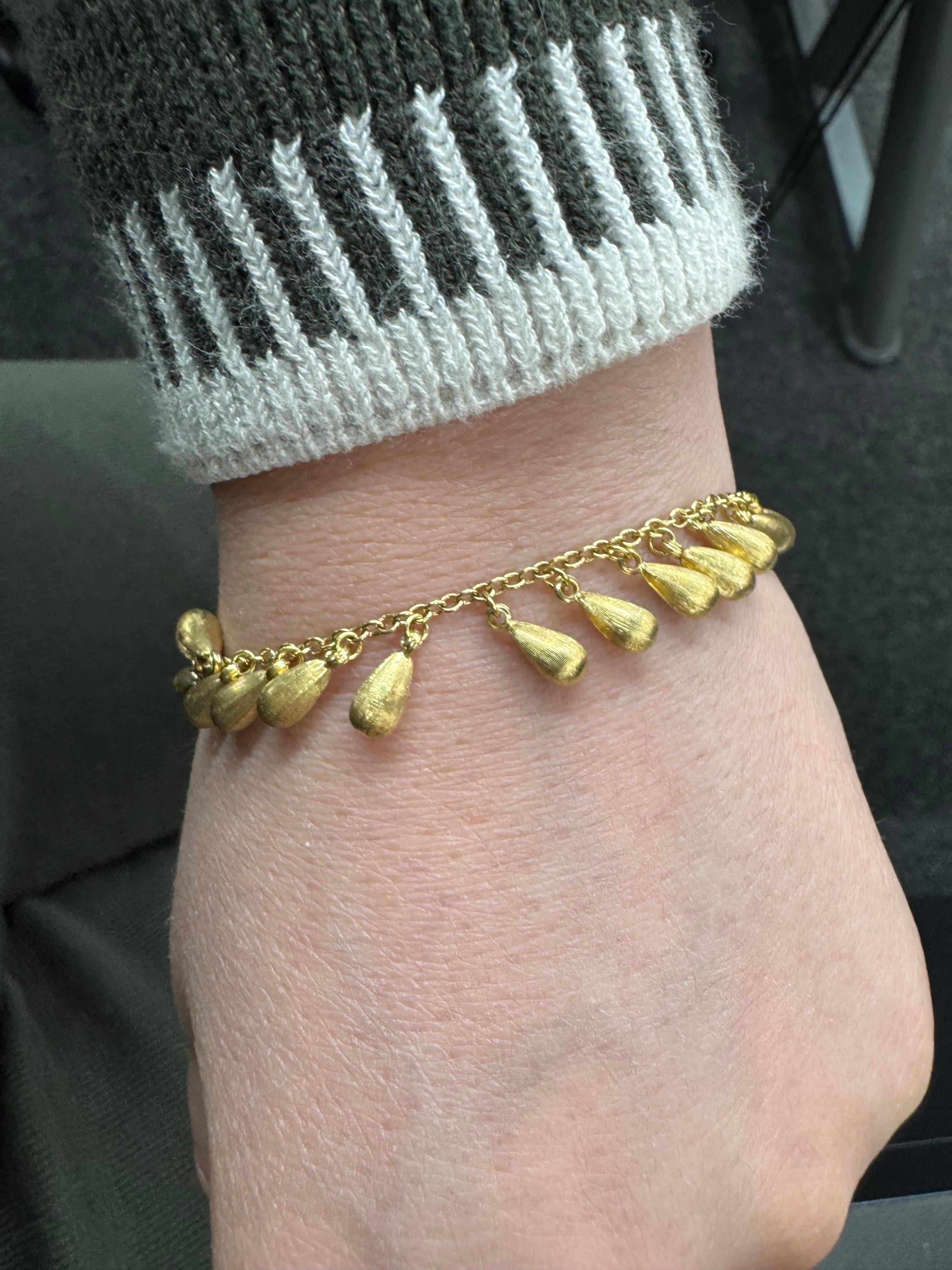18 Karat yellow gold bracelet featuring 27 tear shape links in a brushed finish weighing 12.6 grams. 
Fun & lots of movement. 