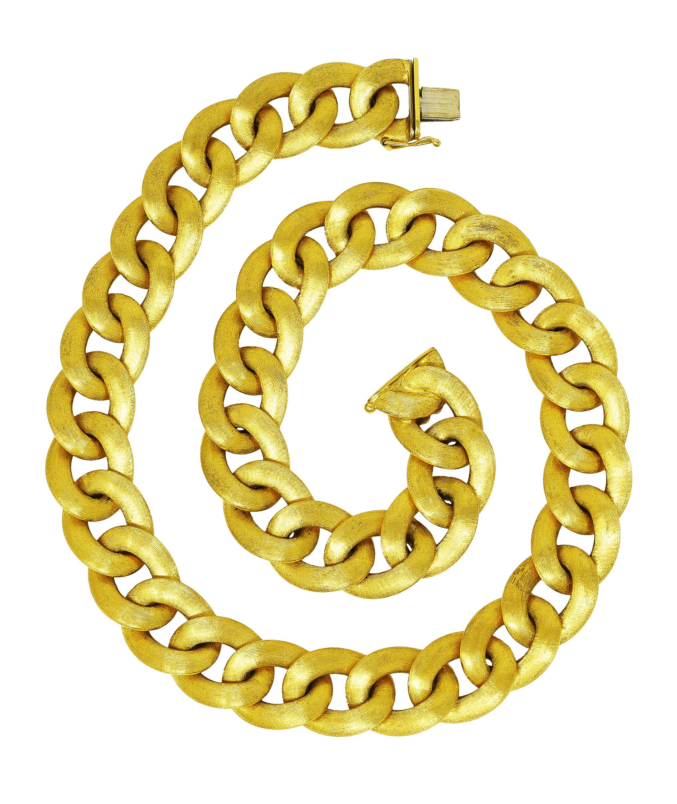 Necklace is comprised of large curb links. With brushed gold texture on one side. Completed by hidden clasp closure with figure eight safety. Stamped 750 with Italian assay marks for 18 karat gold. Circa: 1980's. Length: 18 inches. Width: 5/8 inch.