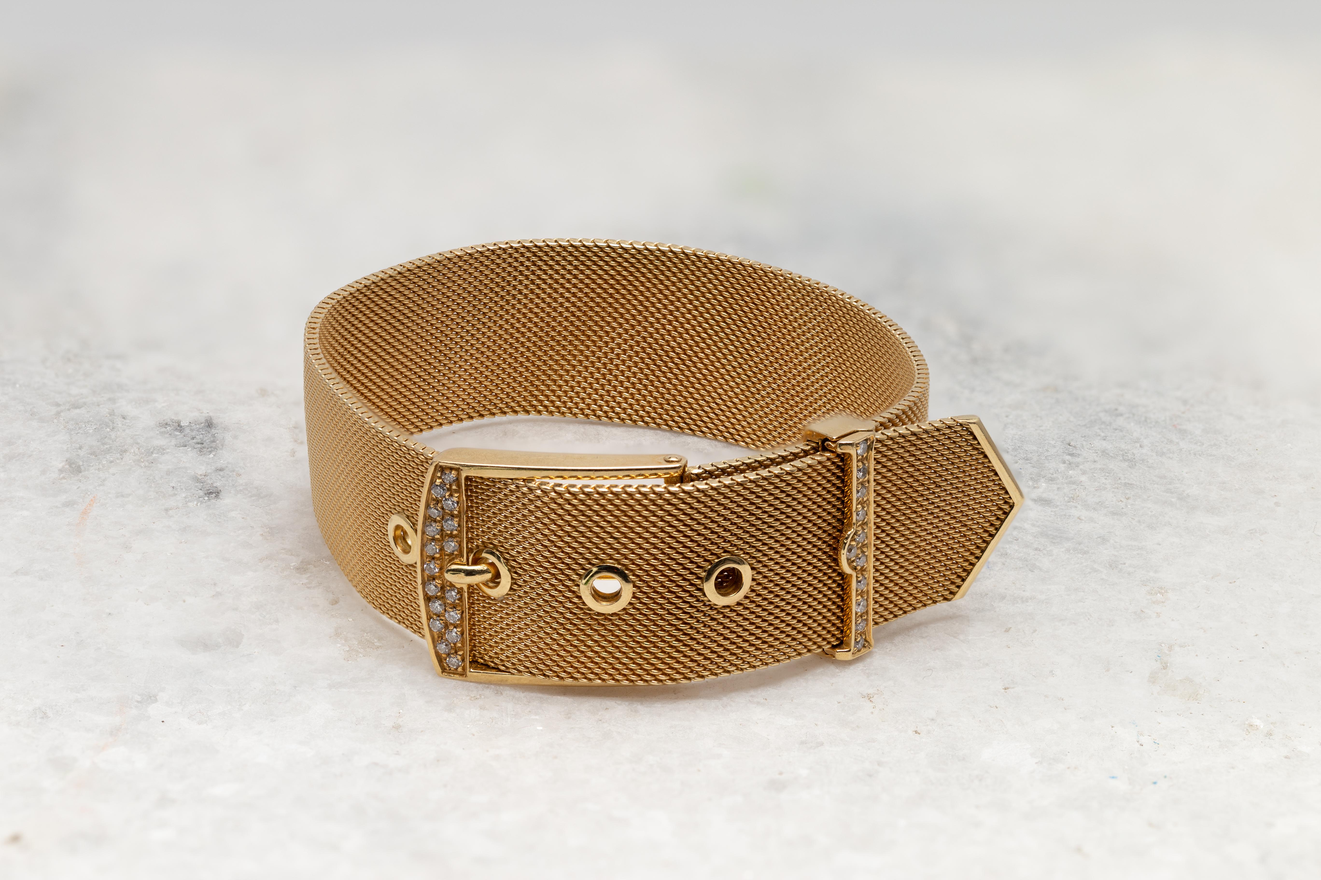 A Modern 18 karat yellow Gold buckle bracelet circa 1960 with round Diamonds. Presenting an 18 karat yellow Gold mesh style structure, this trendy buckle bracelet is delicately accented with 0.40 carat Diamonds. Adjustable to your wrist and weighing