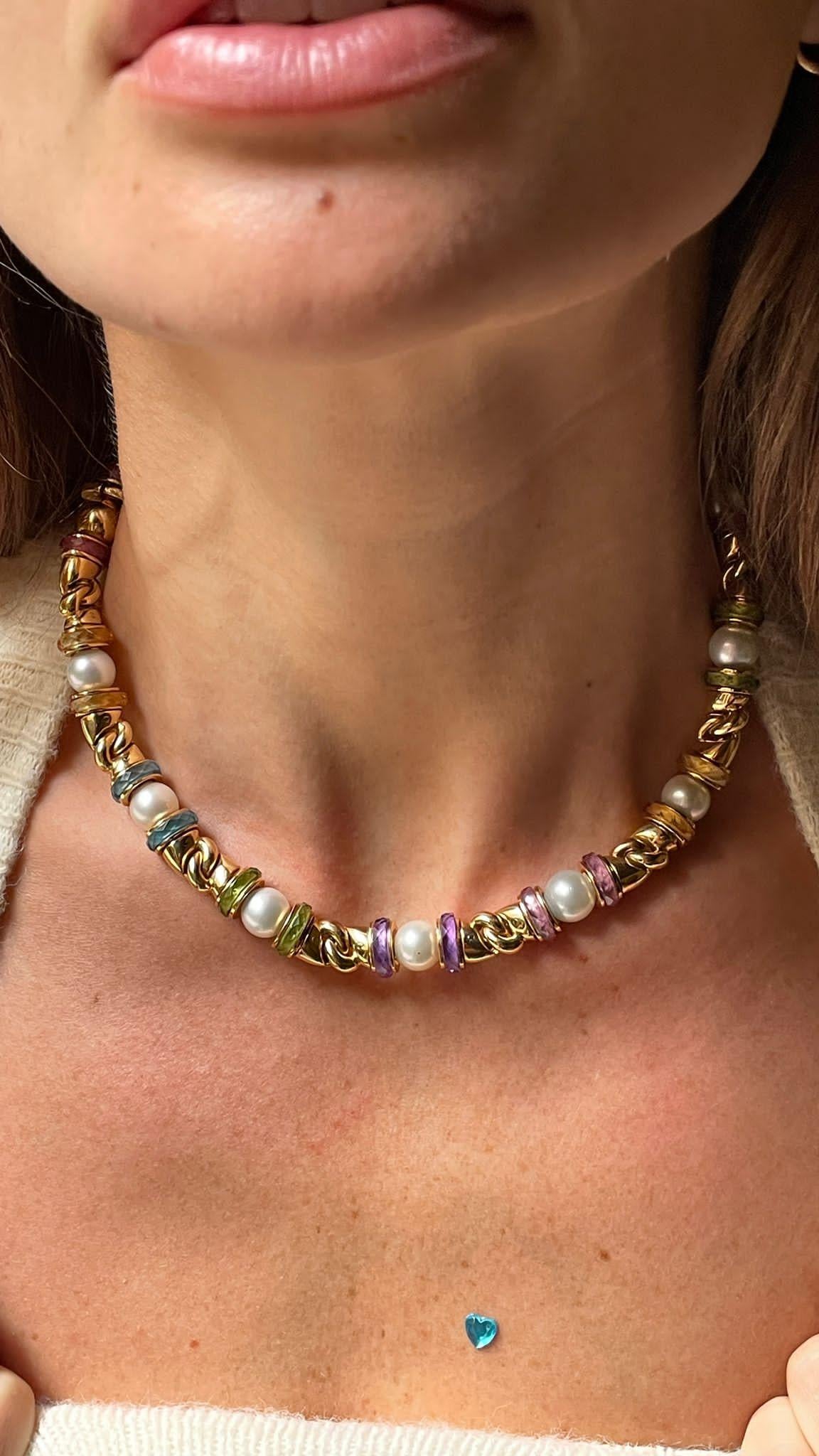 18 Karat Yellow Gold Bulgari Gancio Necklace. The necklace features 17 akoya cultured pearls measuring 7.6mm, beautifully accented by colored sapphires and tormalines rondells weighing 4/5 carats.
Comes in Original Bulgari soft pouch
Matching ring