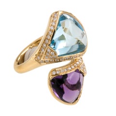 18 Karat Yellow Gold Bypass Ring with 7.64 Ct Blue Topaz & 3.20 Ct. Amethyst