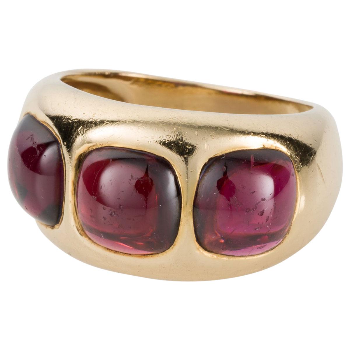 I love this ring, it's chunky and it's cool. Buttery 18k yellow gold with a soft patina outlines these gorgeous candy like cabochon garnets. They have a certain glow, a deep red tone in some directions when the light hits the top of the gemstone to