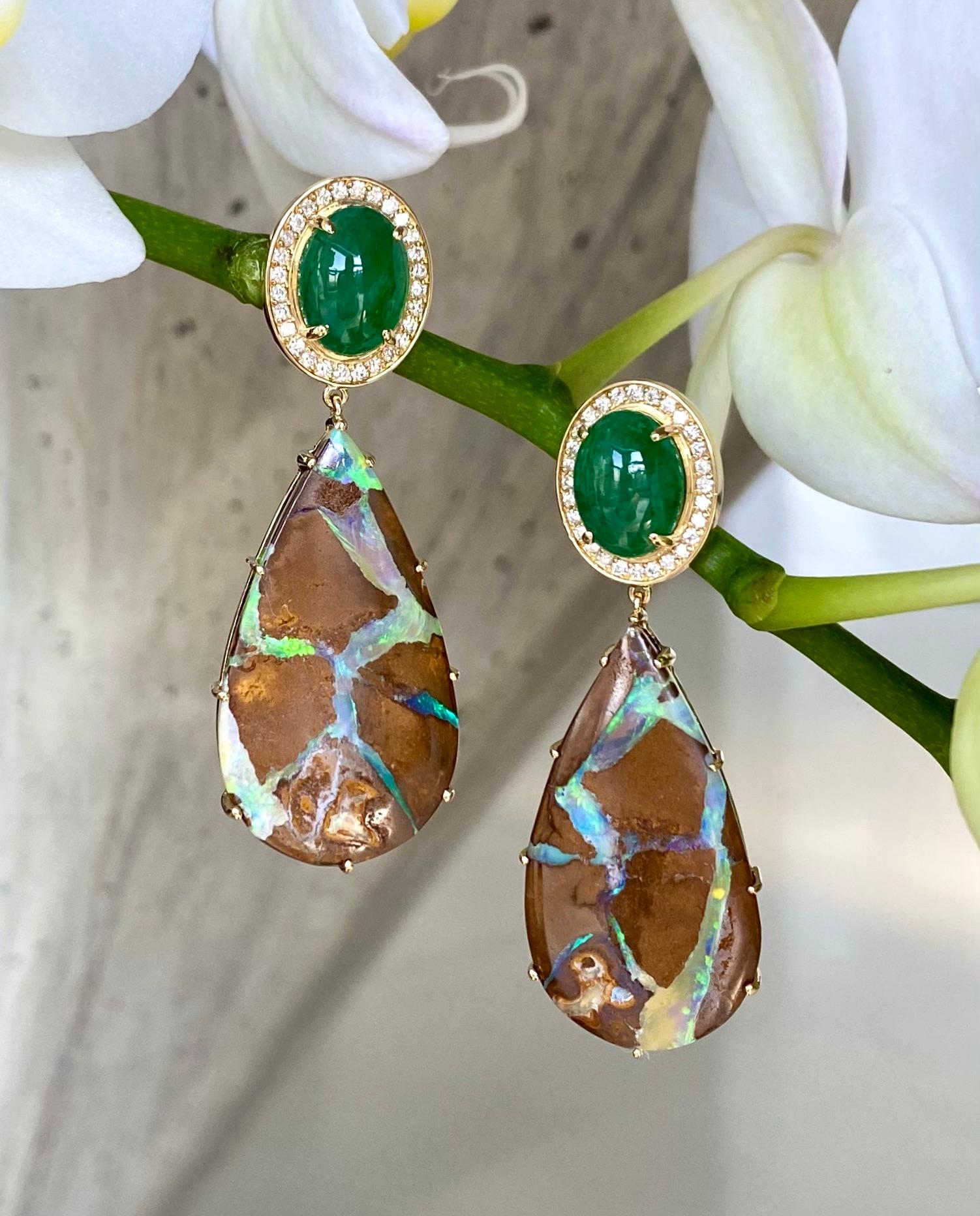 Drop dangle earrings of oval cabochon tsavorites surrounded by diamond pave, with pear shaped boulder opal drops, handcrafted in 18 karat yellow gold.

These one-of-a-kind earrings of gorgeous tsavorites, boulder opals and diamonds reflect the