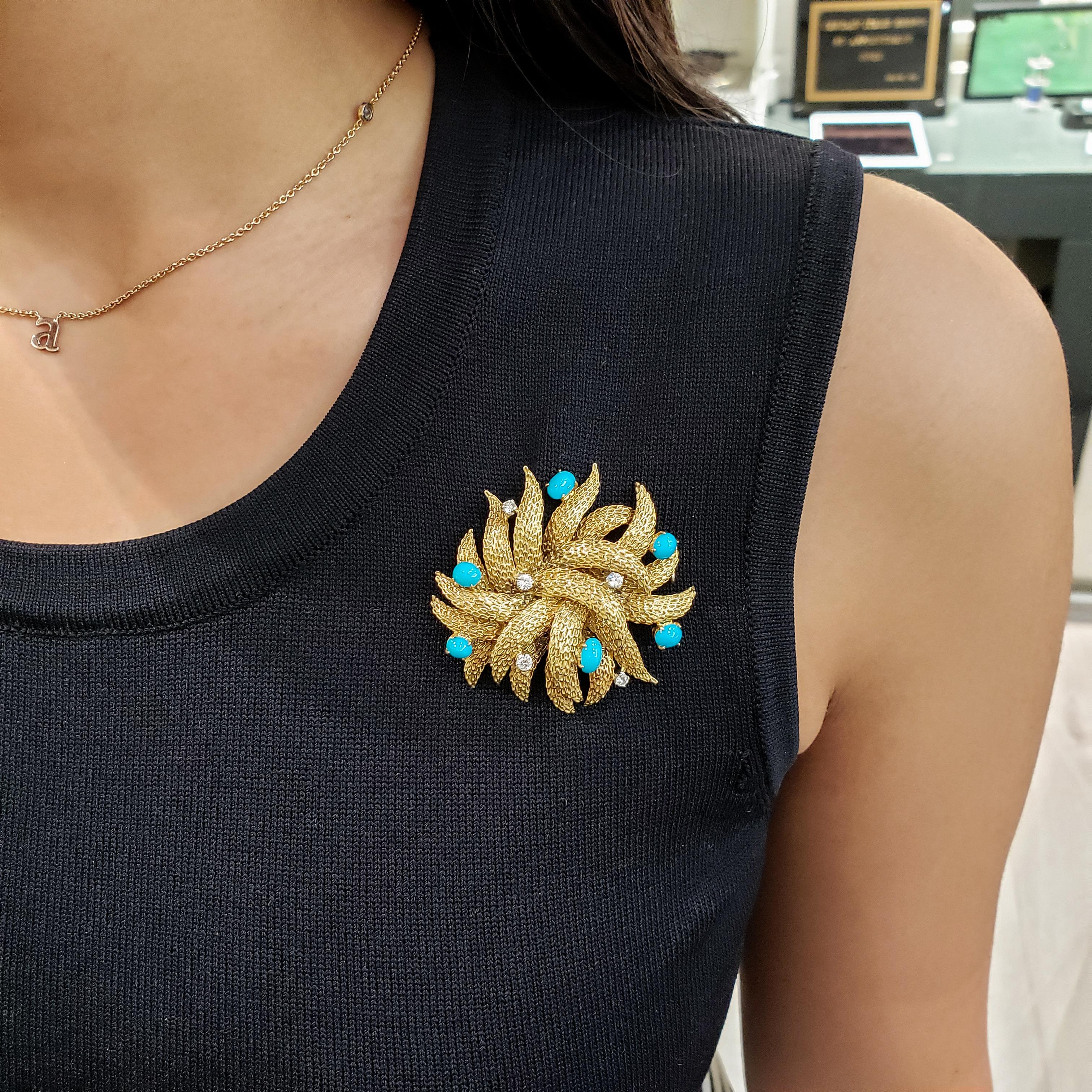 A reef-like figure made in 18 karat yellow gold, accented by 6 cabochon turquoise and 5 round diamonds. hand-engraved.