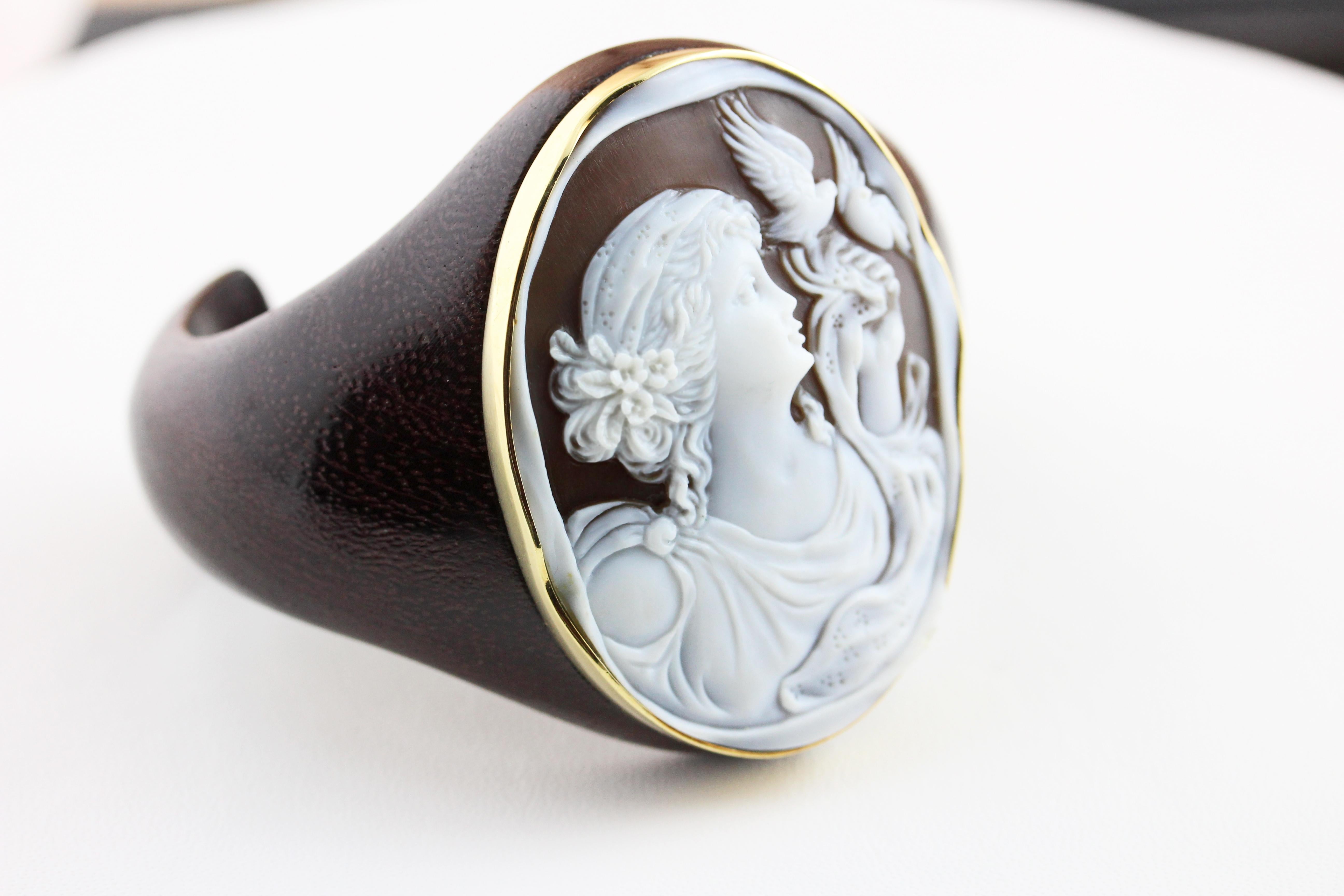 Cuff bracelet hand carved, made in wood topped with a cameo on the center, finished with an 18 karat yellow gold band.

Weight:
            60 gr circa

All AVGVSTA jewelry is new and has never been previously owned or worn. Each item will arrive