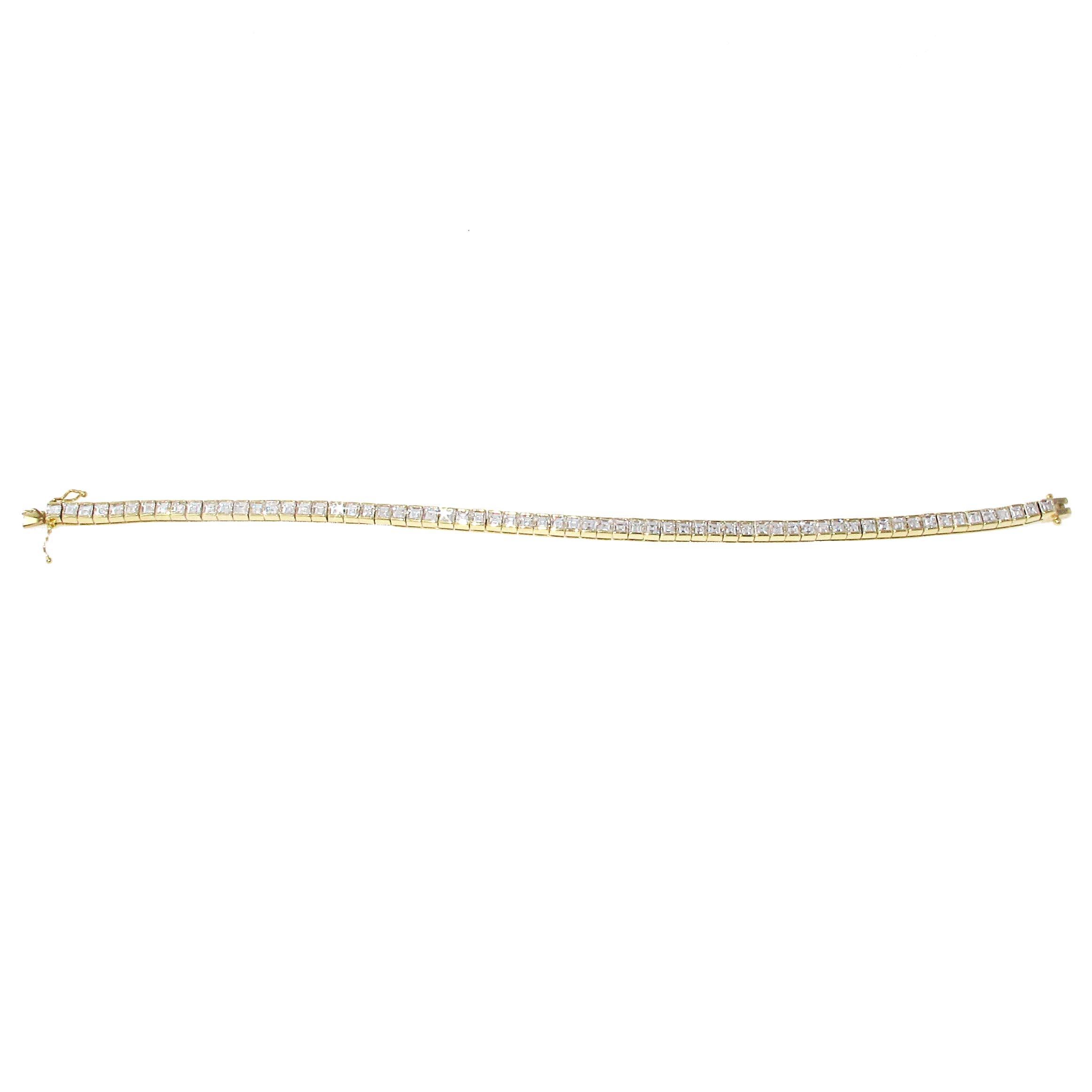Rare 18 karat yellow gold Carre' diamond tennis bracelet. The bracelet is made with 65 Carre' Cut diamonds weighing approximately 6.13 carats. The diamonds are approximately H-I color and  VS clarity. The diamonds are channel set which protects the