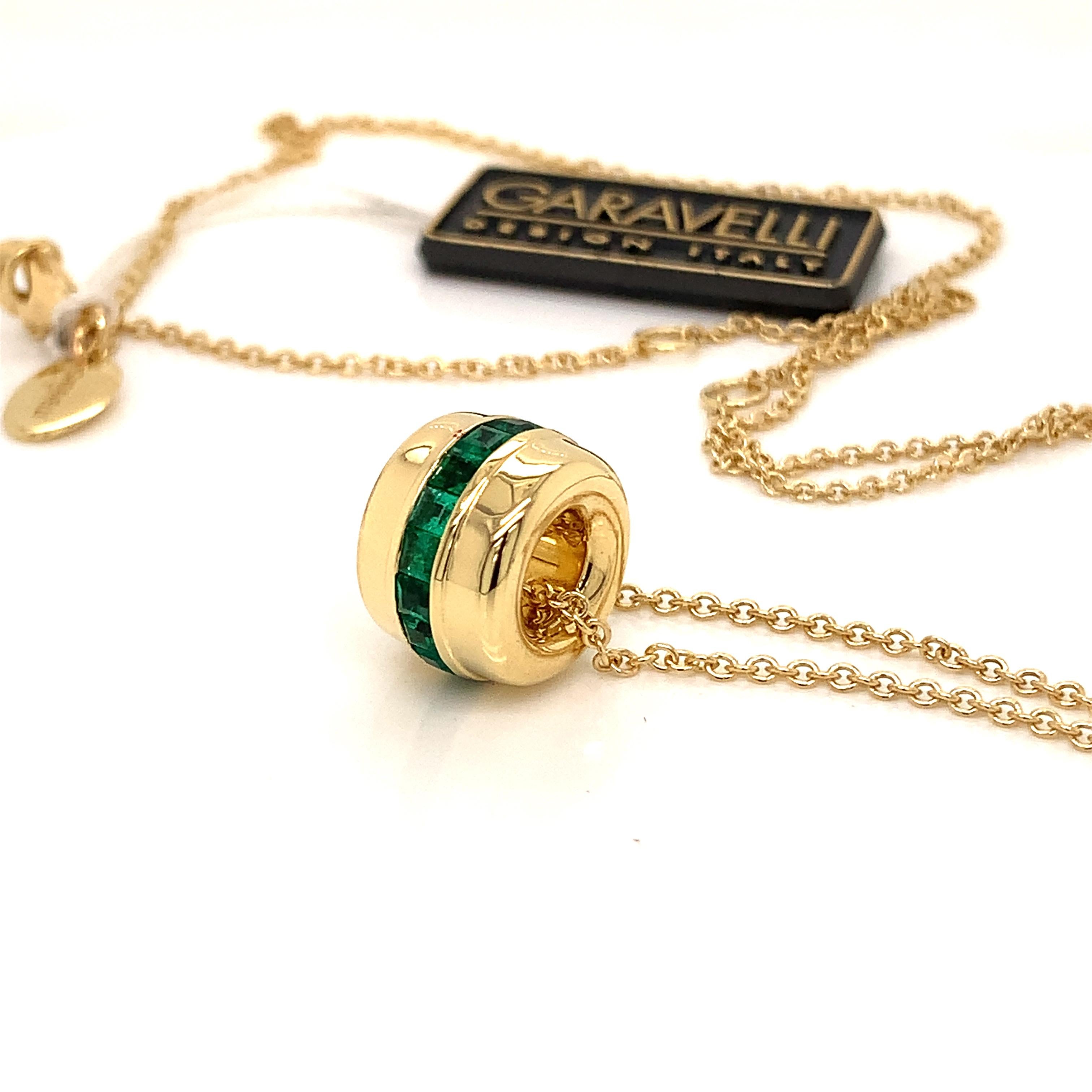 18 Karat Yellow Gold Emeralds  GARAVELLI Pendant with chain  , this pendants features seventeen perfectly square cut emeralds set in yellow gold  Matching  rings and huggie earrings also available. 
The Pendant diameter is 18mm  ;  total chain
