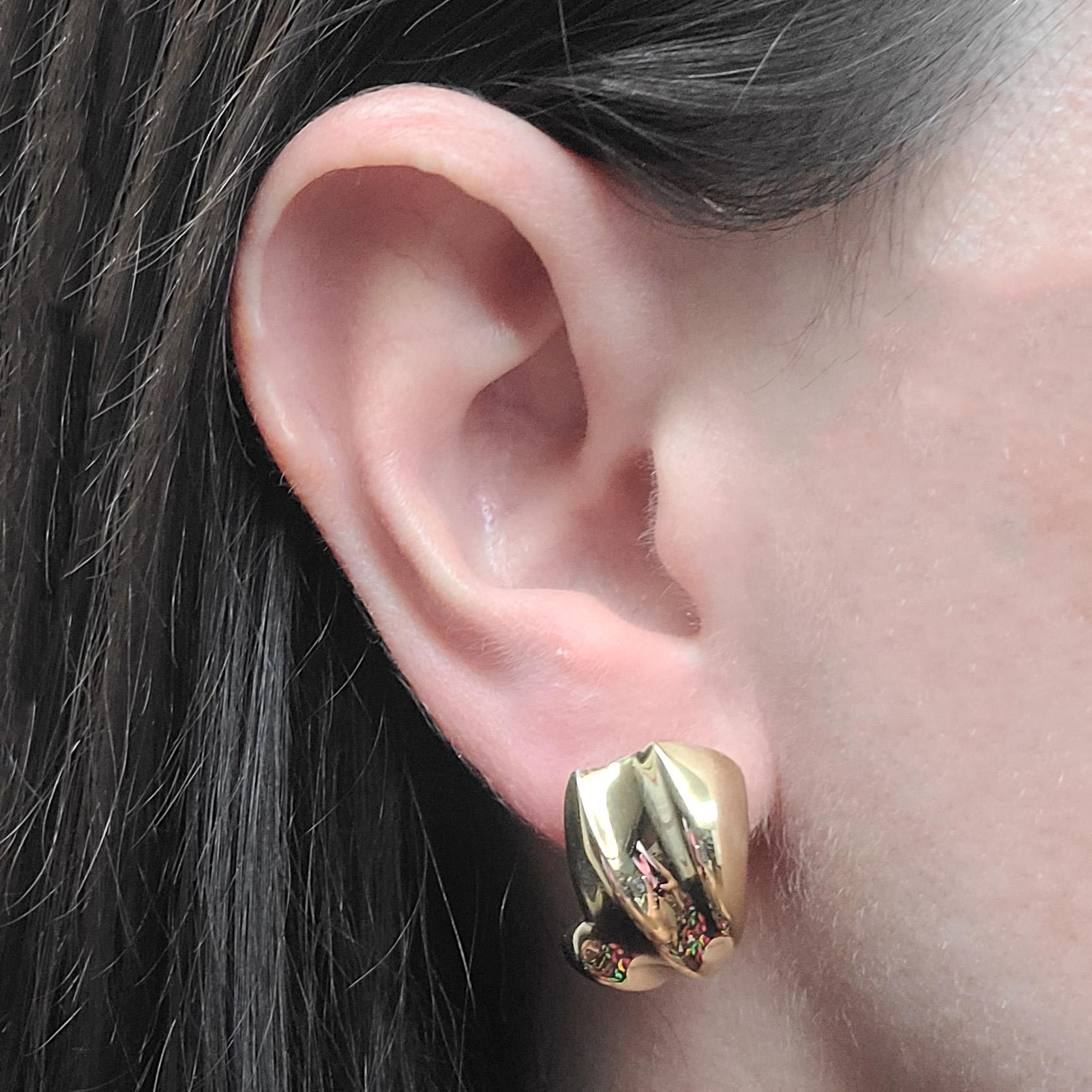 18 Karat Yellow Gold Earrings Featuring A Polished Carved Design. Pierced Post With Omega Clip Back. Post Can Be Removed Upon Request. Finished Weight Is 9.8 Grams.