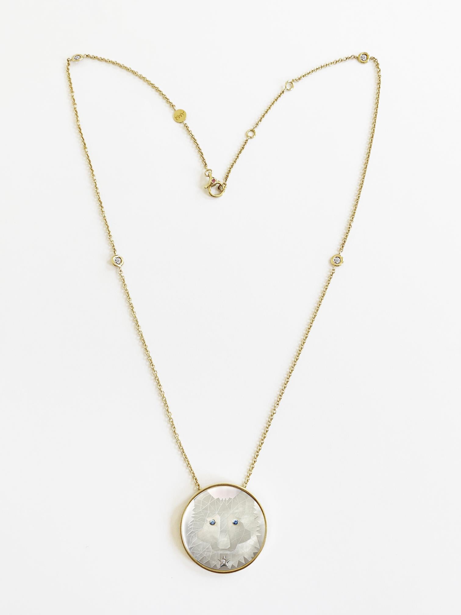 Art Wild Collection:  Lady Wolf Pendant.
Yellow Gold Pendant and chain ( it measure 40mm with diamonds)
This necklace features a unique engraved, carved and engraved white mother of pearl with natural blue sapphires eyes and a centered white gold
