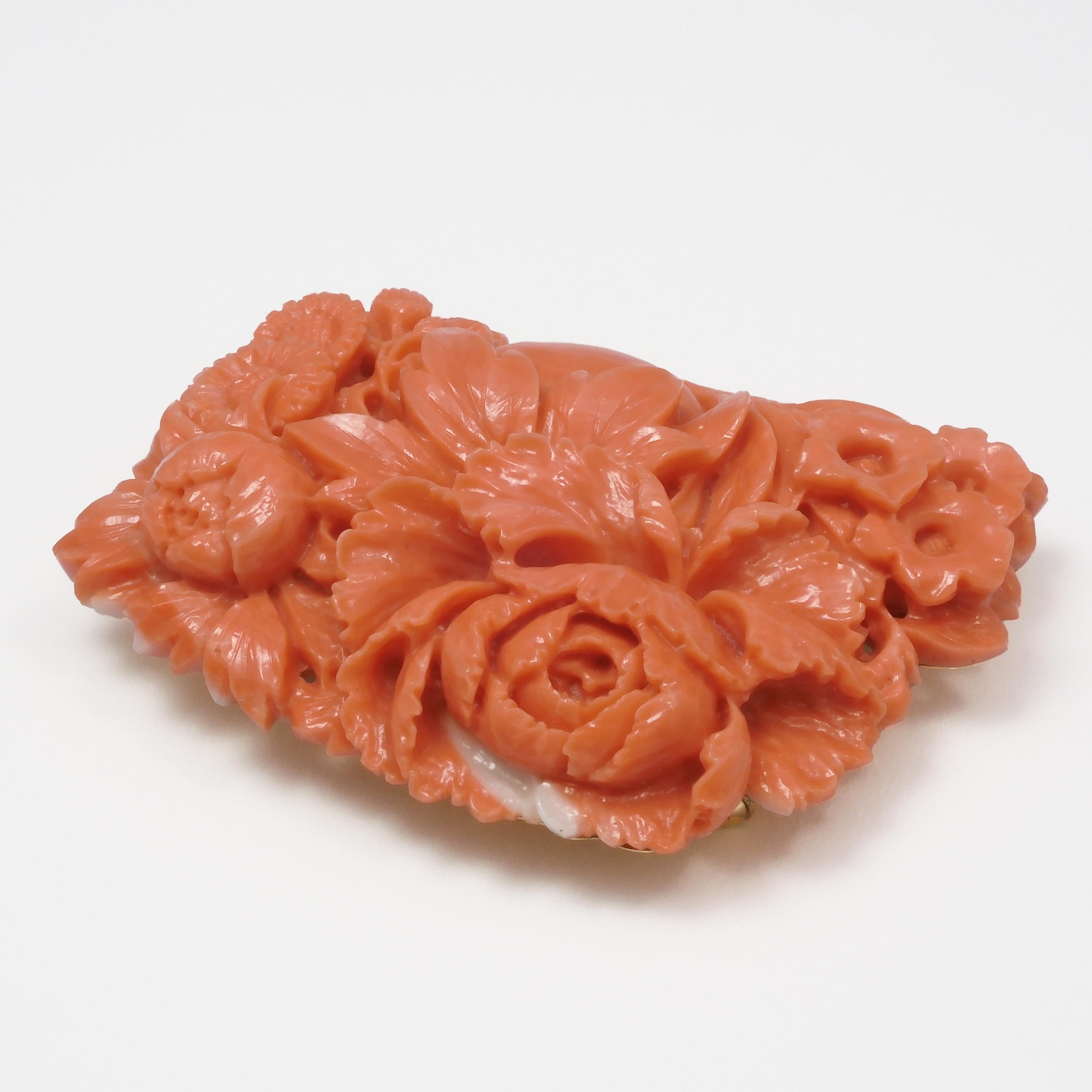 This vintage Japanese Momoiro Sango Coral plate Brooch/Obidome is delicately carved into a peony flower.  This is a gentle color for Japanese Momoiro Sango, featuring a slight pink hue. There is very little color unevenness, and the white spot on