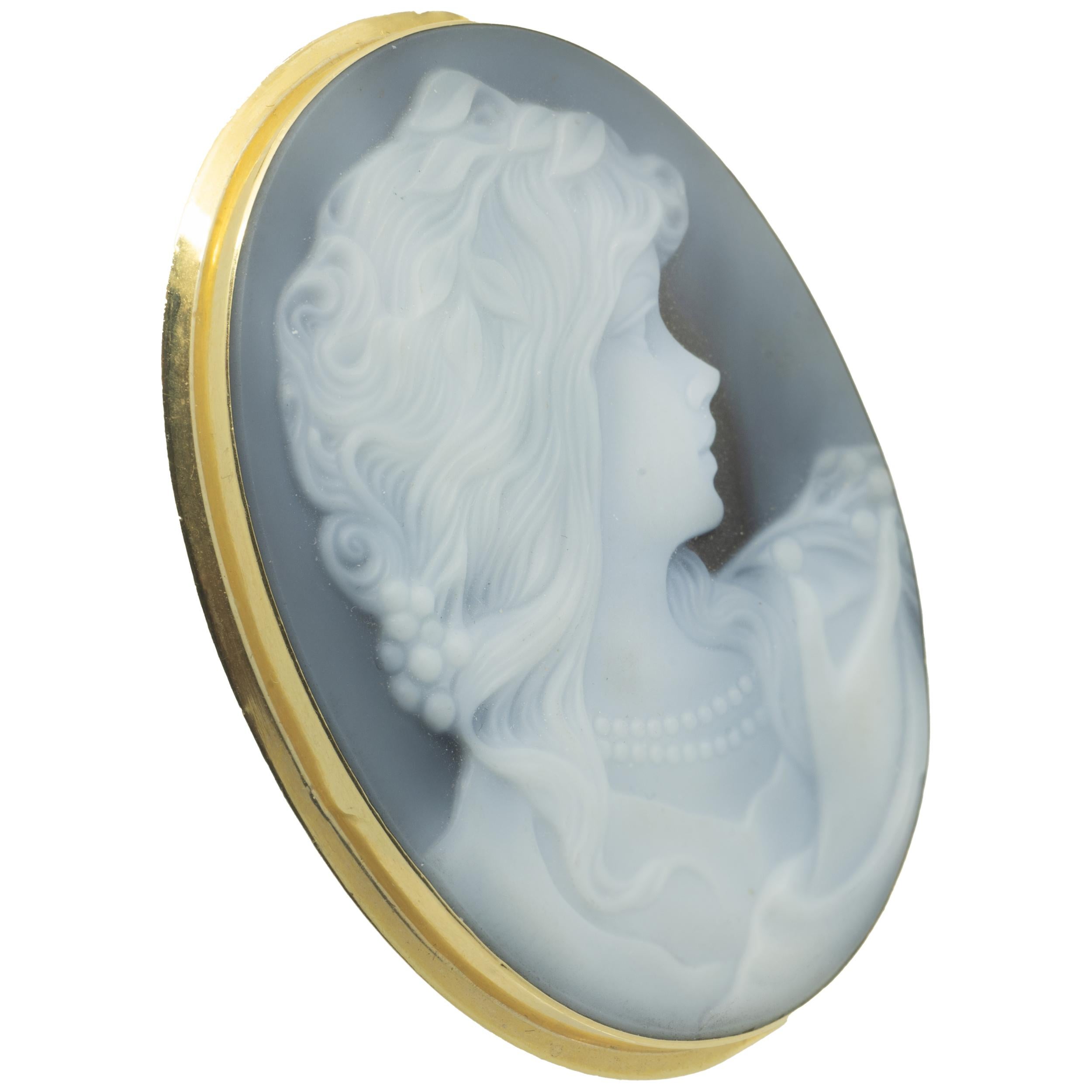 Designer: custom
Material: 18K yellow gold
Gemstone: carved onyx
Dimensions: pin is approximately 52mm by 42mm
Weight: 13.64 grams
